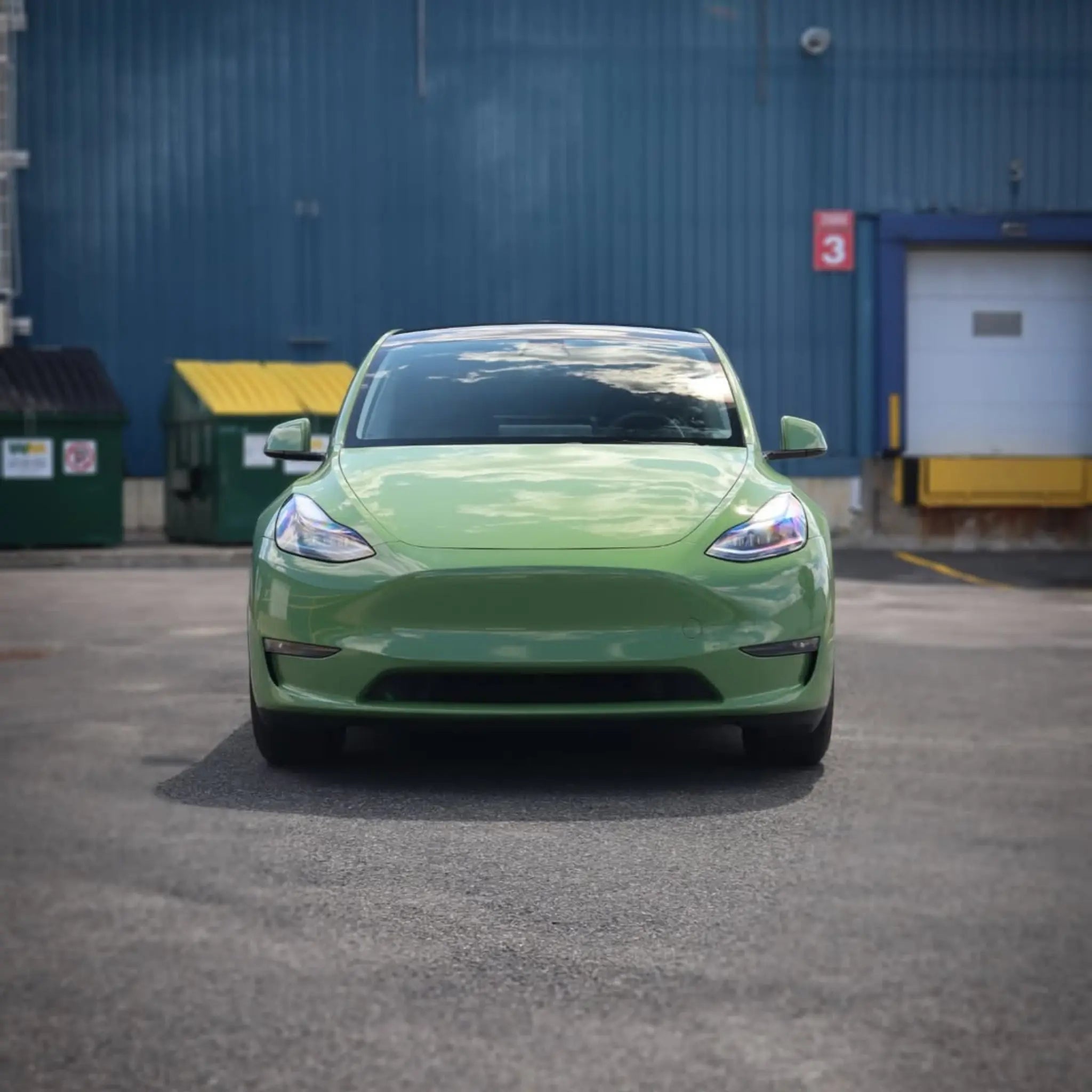 Front view of Tesla Model Y in Gloss Porsche Olive Green wrap - Kaleido
