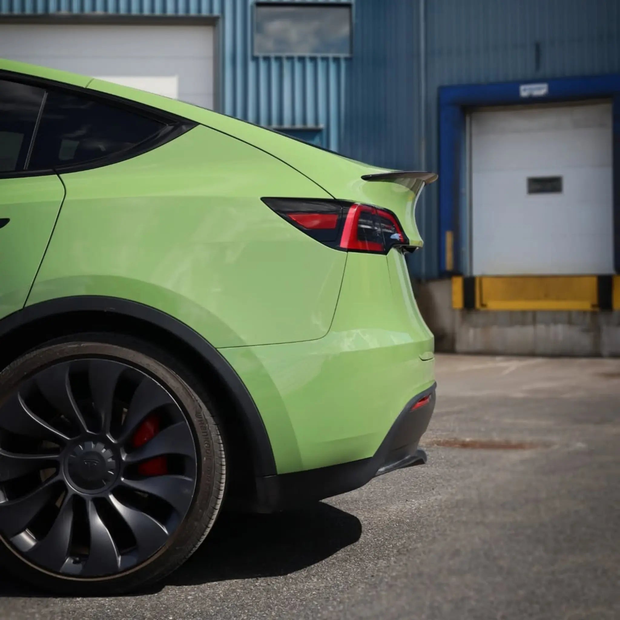 Gloss Porsche Olive Green film on Tesla Model Y left rear corner - Kaleido