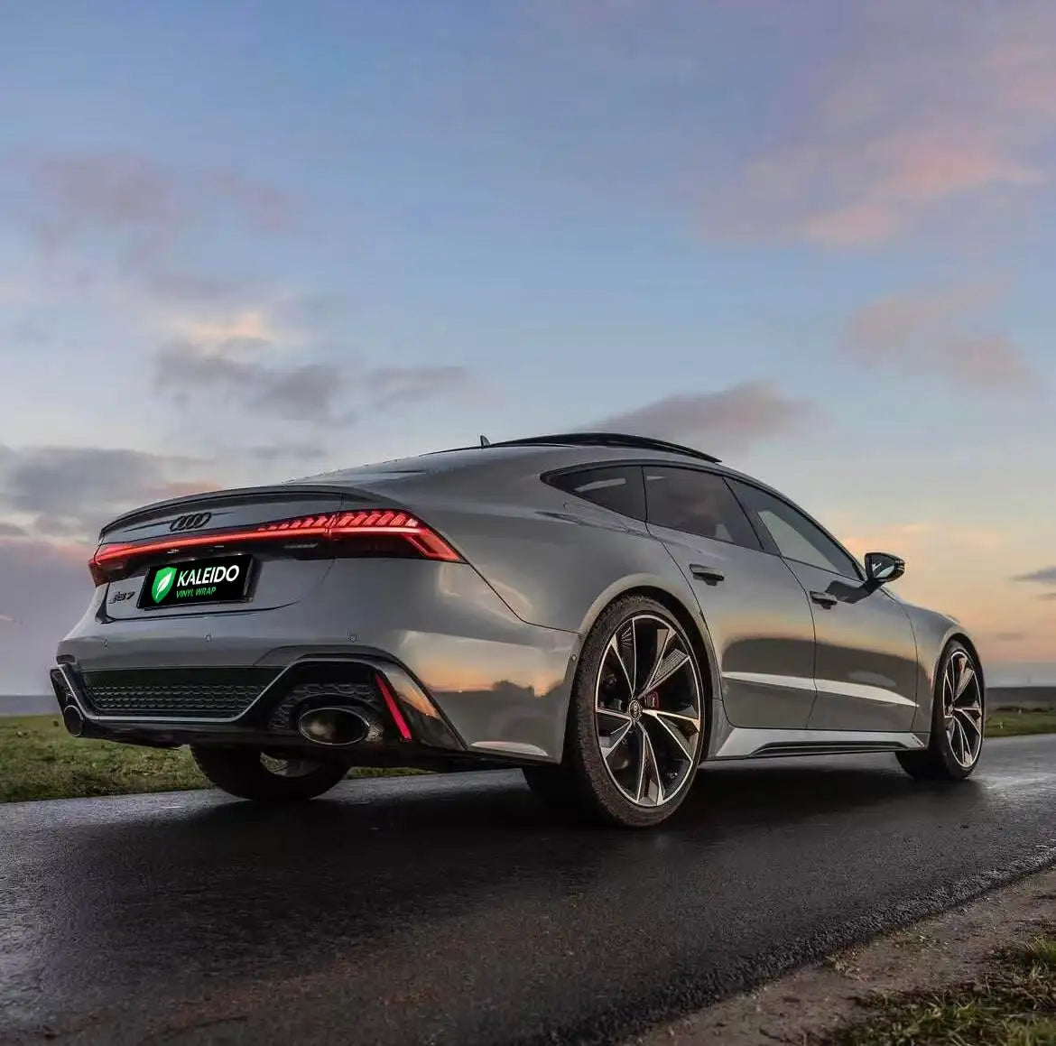 Rear-right view of a Gloss RS Nardo Grey Deep Audi RS7 Sportback - Kaleido
