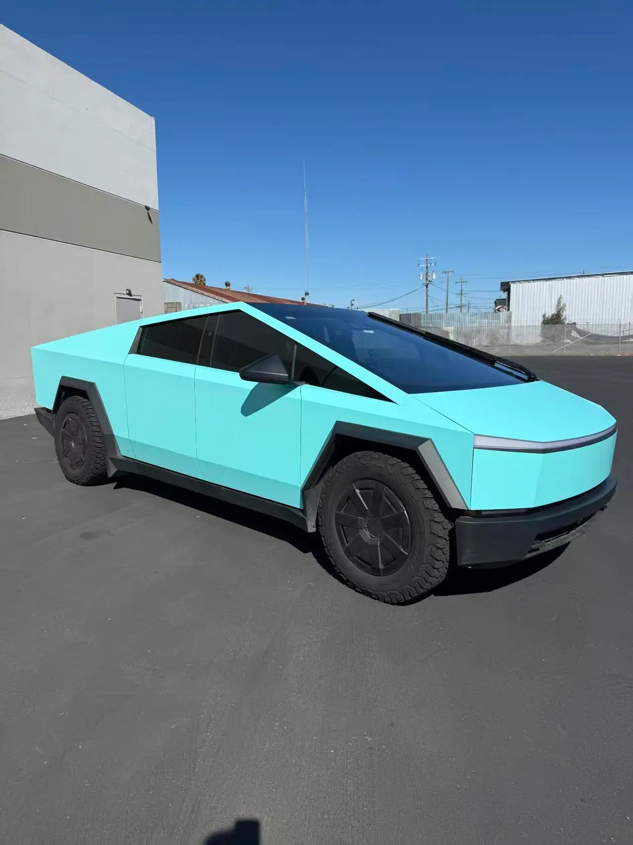 Wide front-right view of Gloss Tiffany wrapped Tesla Cybertruck - Kaleido