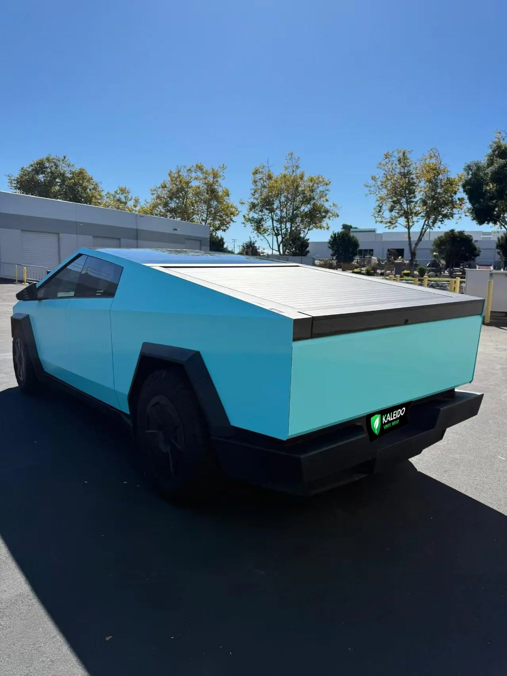Wide rear-left view of Tesla Cybertruck with Gloss Tiffany vinyl wrap - Kaleido
