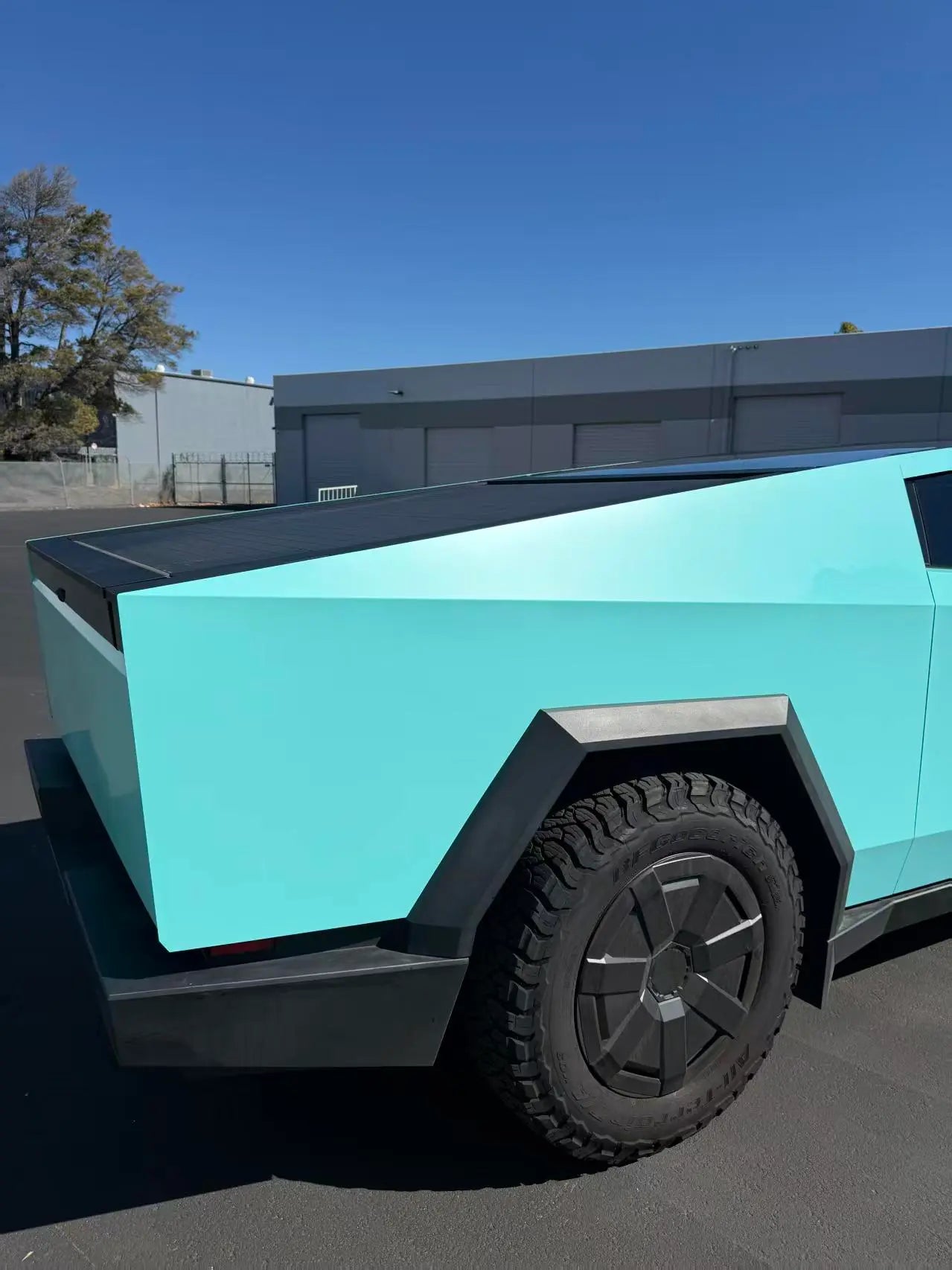 Detailed shot of Gloss Tiffany vinyl on Tesla Cybertruck rear-right panel - Kaleido