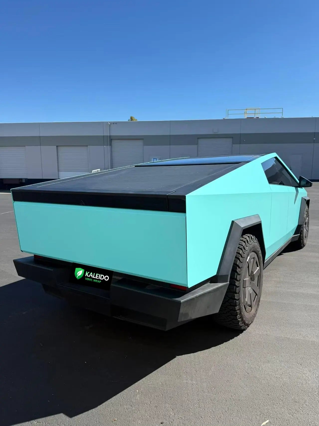 Tesla Cybertruck with Gloss Tiffany film - wide rear-right view showing truck bed area - Kaleido