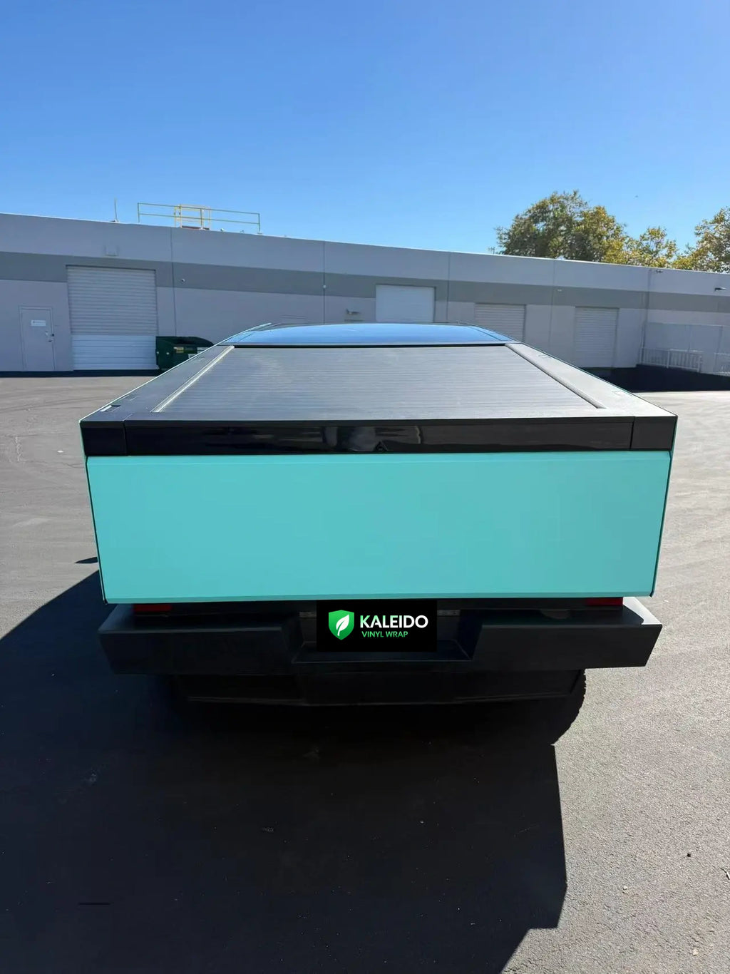 Rear view of Tesla Cybertruck in Gloss Tiffany blue-green vinyl wrap - Kaleido