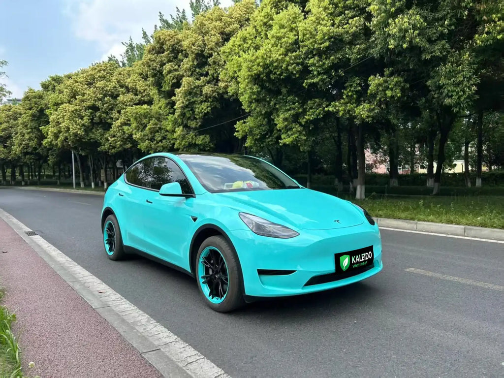 Wide front-right view of Tesla Model Y in Gloss Tiffany blue-green vinyl - Kaleido