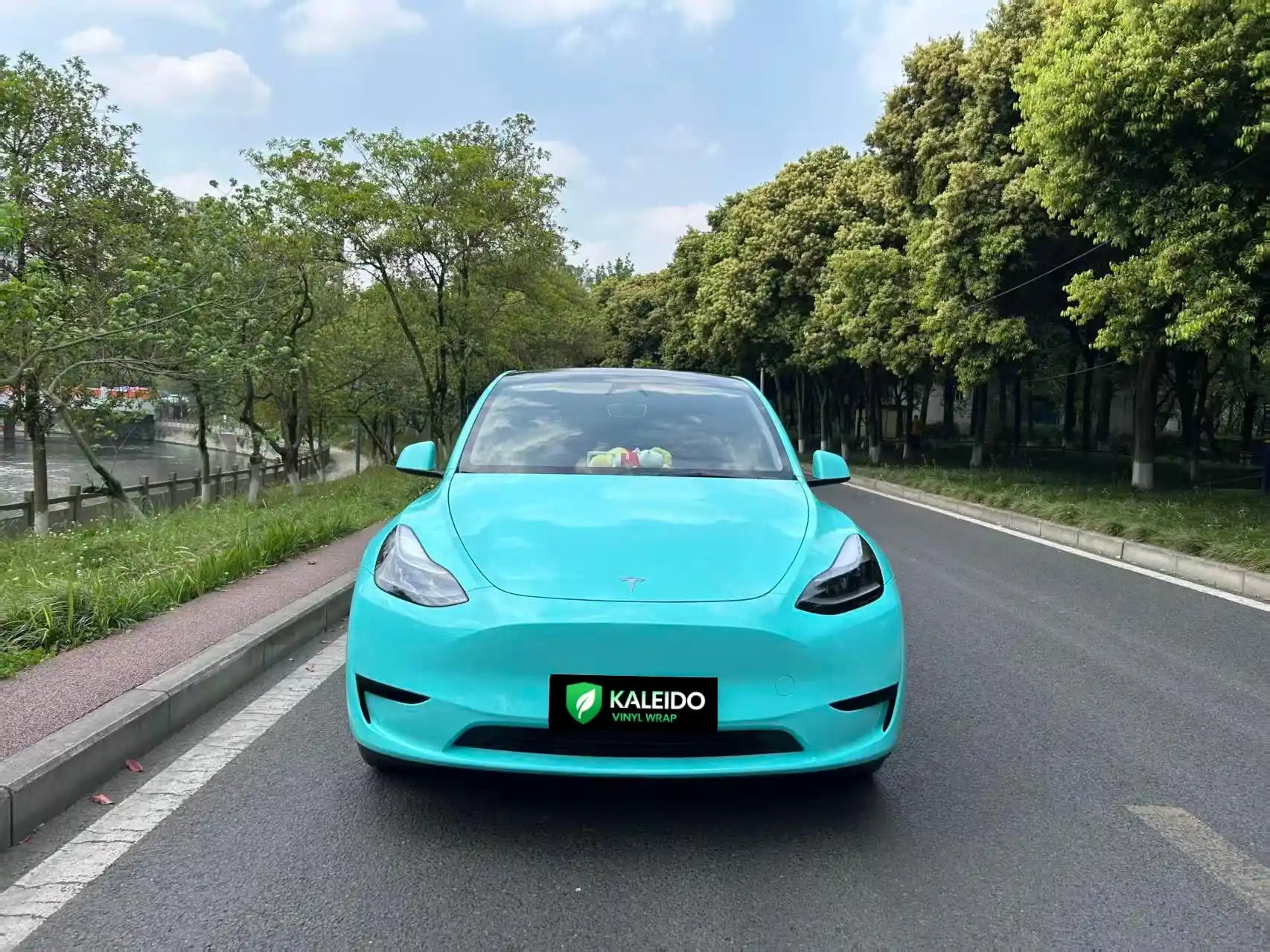 Front view of Tesla Model Y in Gloss Tiffany iconic blue-green wrap - Kaleido