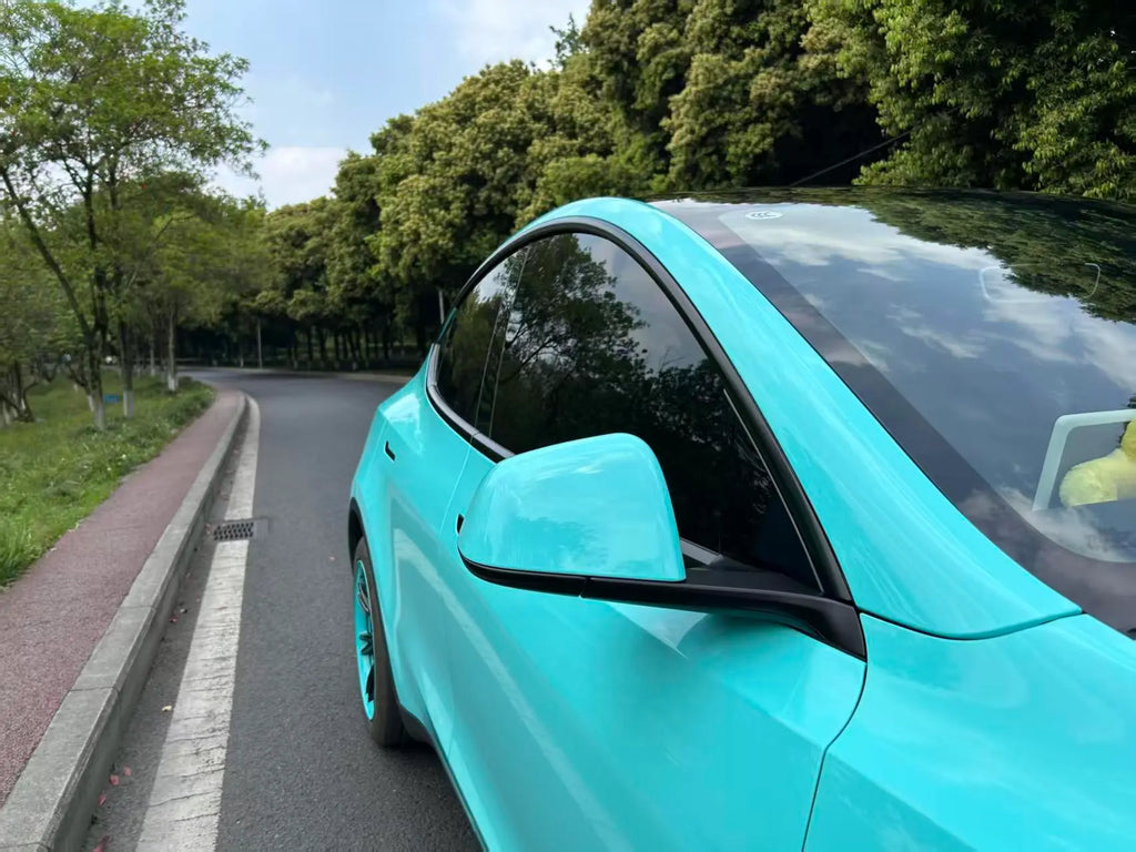 Close-up detail of Gloss Tiffany vinyl on Tesla Model Y side mirror - Kaleido
