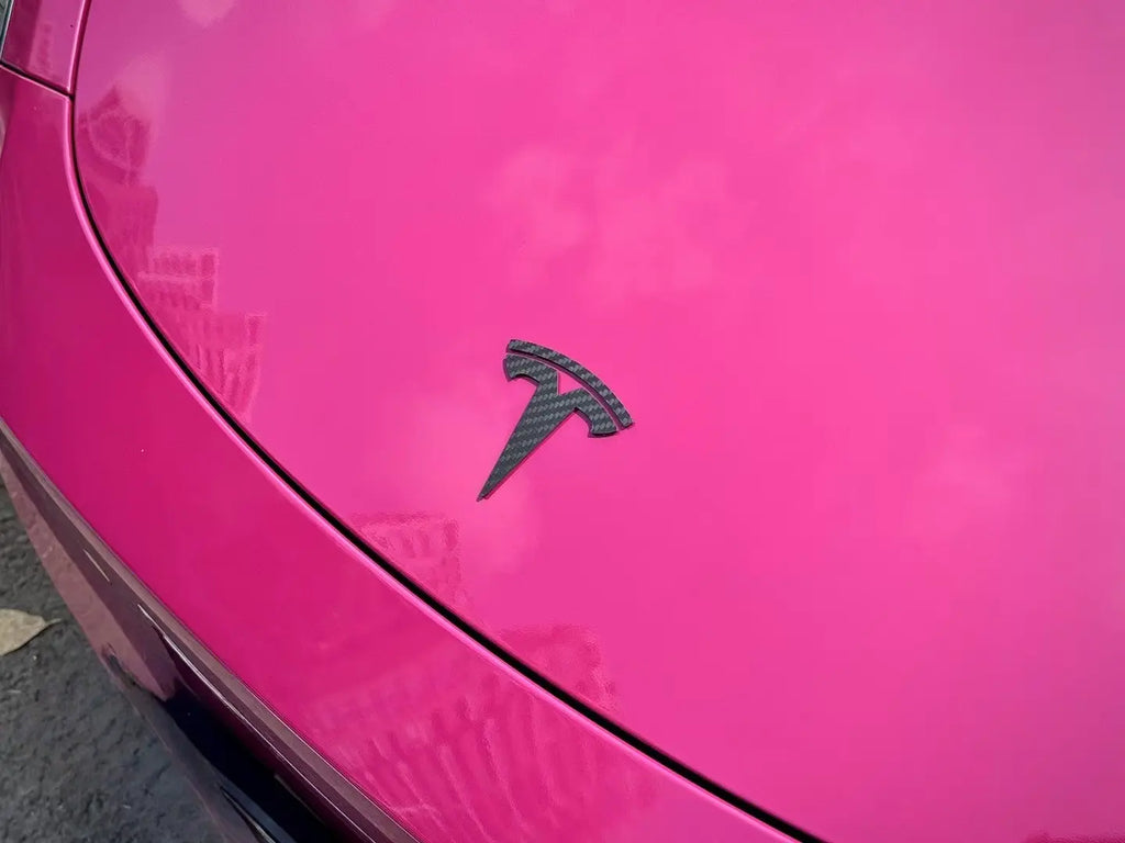 Close-up of Ruby Night Star wrap around Tesla Model Y hood emblem - precise cutting work - Kaleido