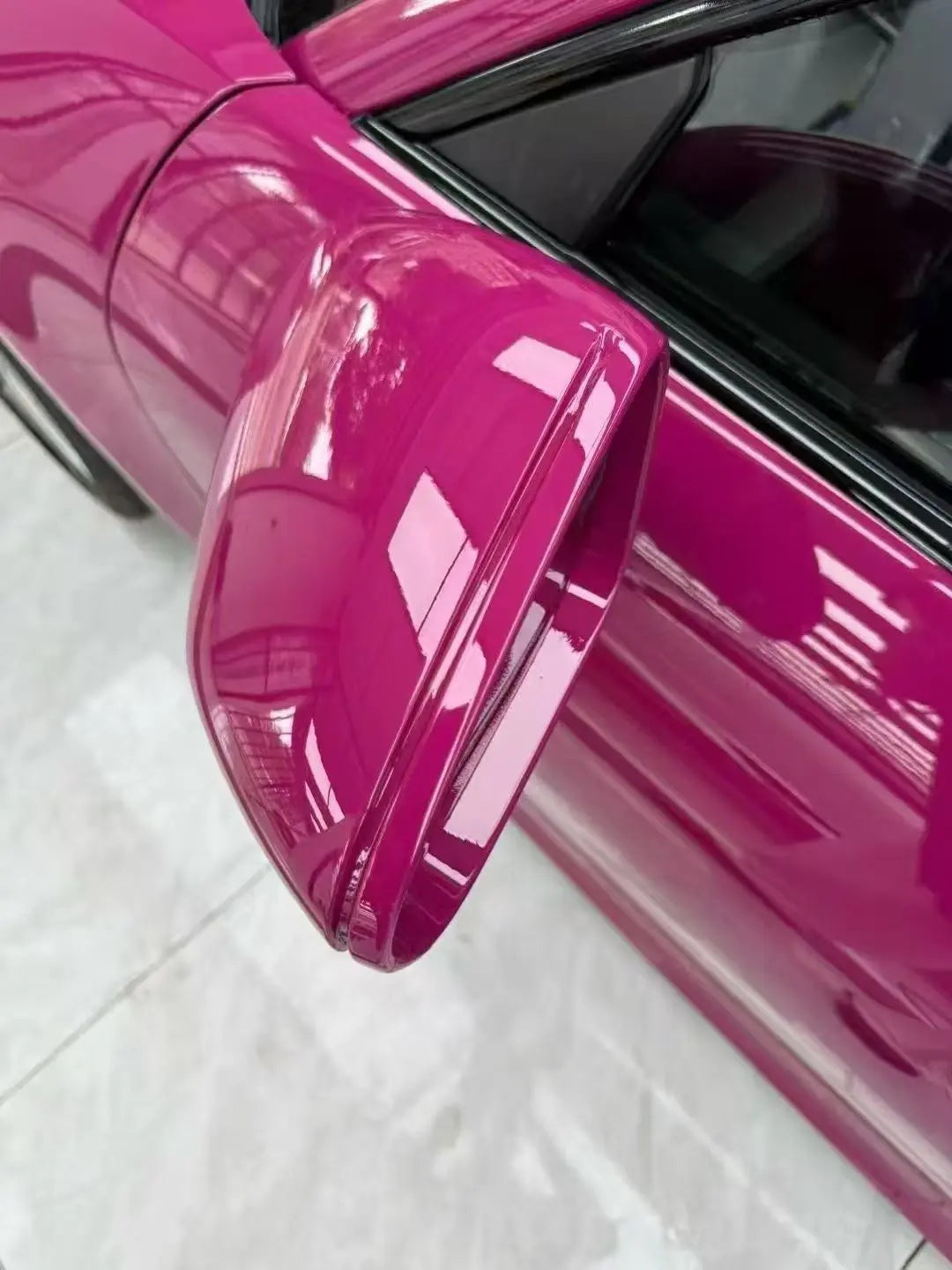 Macro detail of Ruby Night Star wrap on Tesla Model Y side mirror - flawless installation - Kaleido