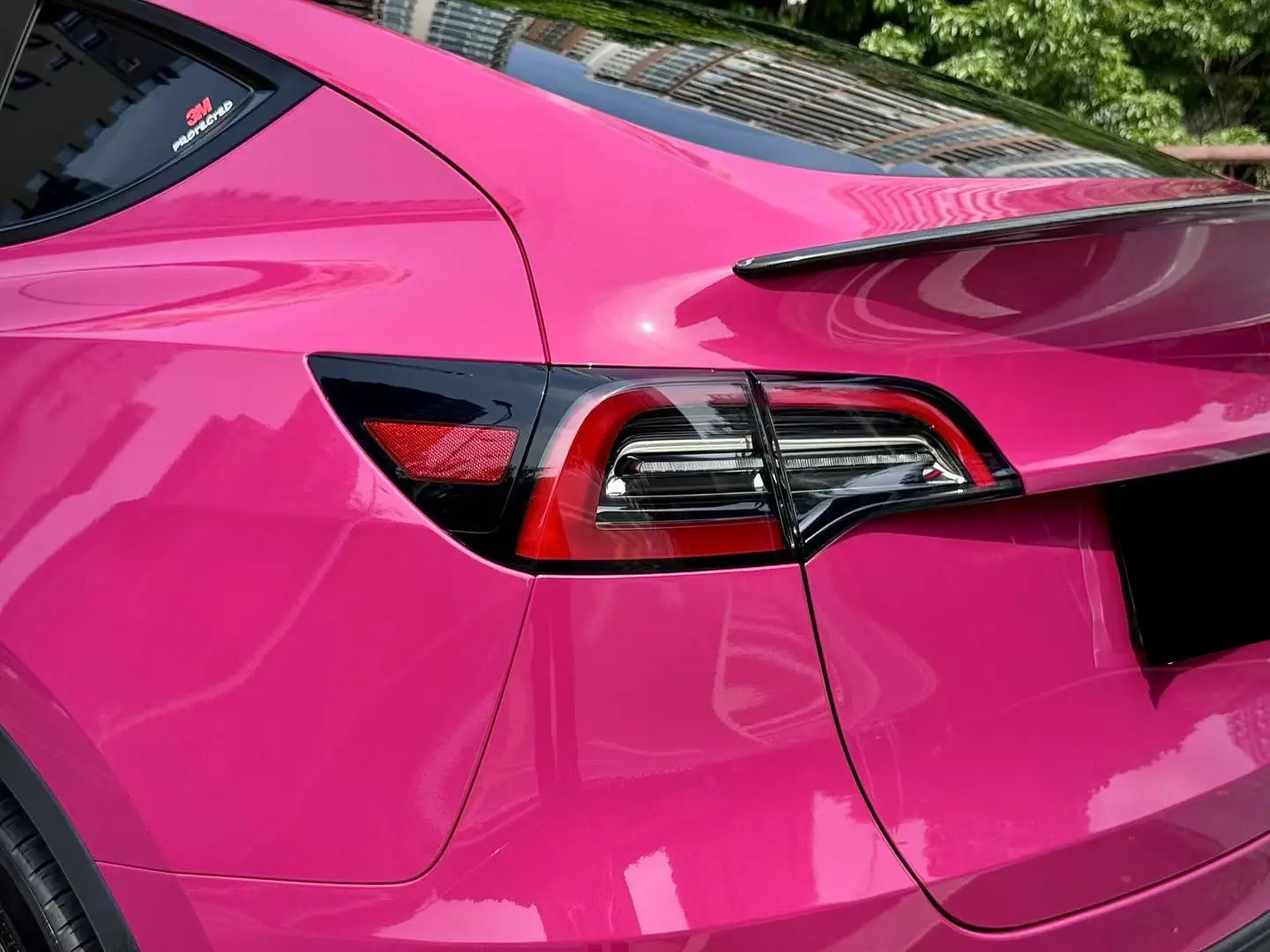 Ruby Night Star gloss vinyl wrap on Tesla Model Y left rear taillight - precise color matching showcase - Kaleido