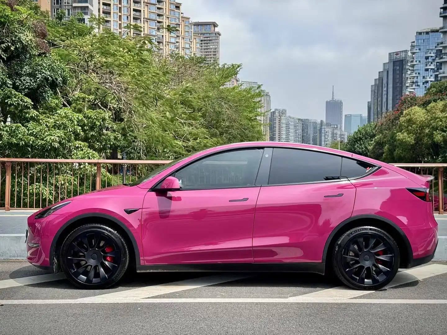 Full side view of Tesla Model Y in Ruby Night Star gloss vinyl - Porsche OEM color match - Kaleido