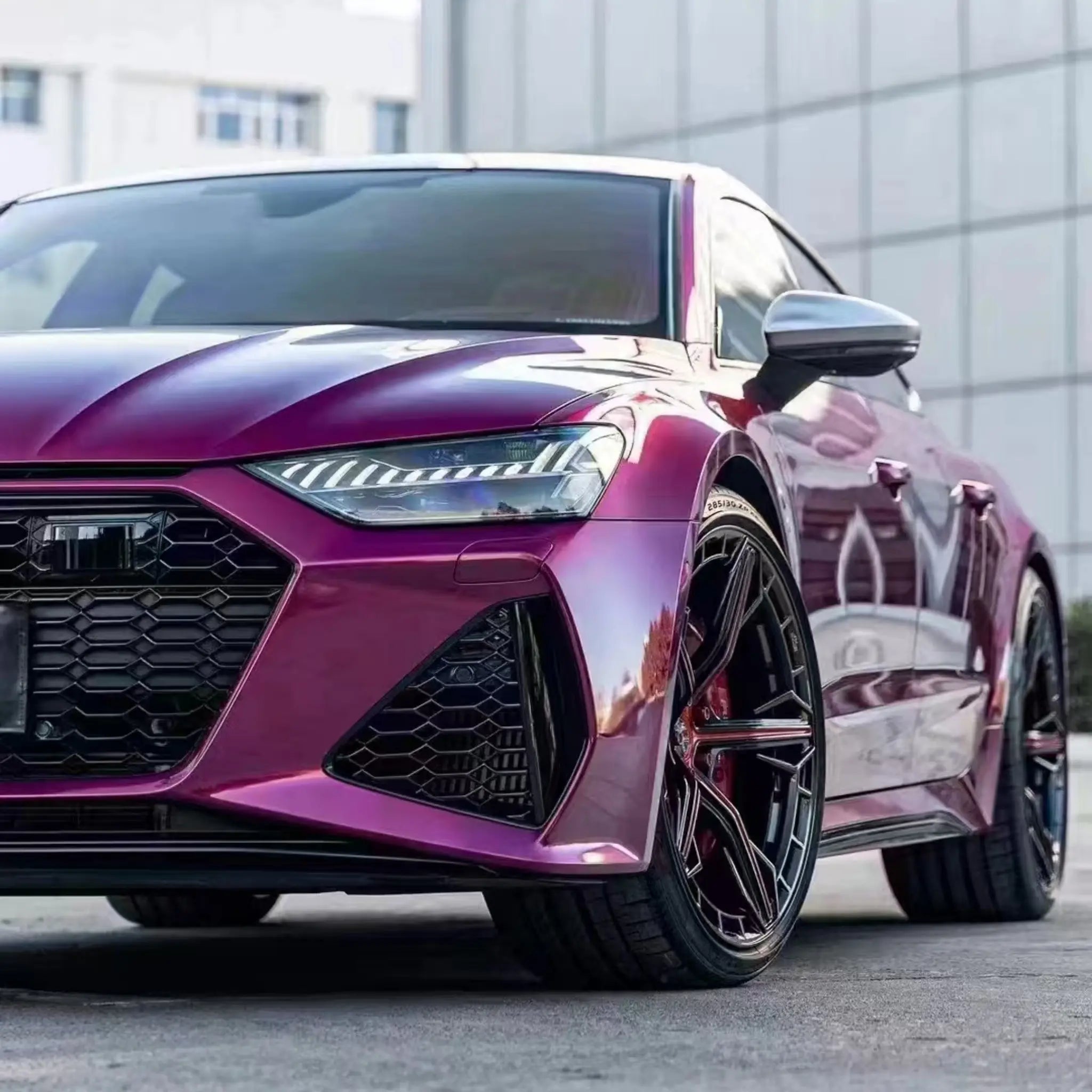 Close-up of Glossy Metallic Rubellite Purple wrap on Audi RS7 Sportback left front headlight area - Kaleido