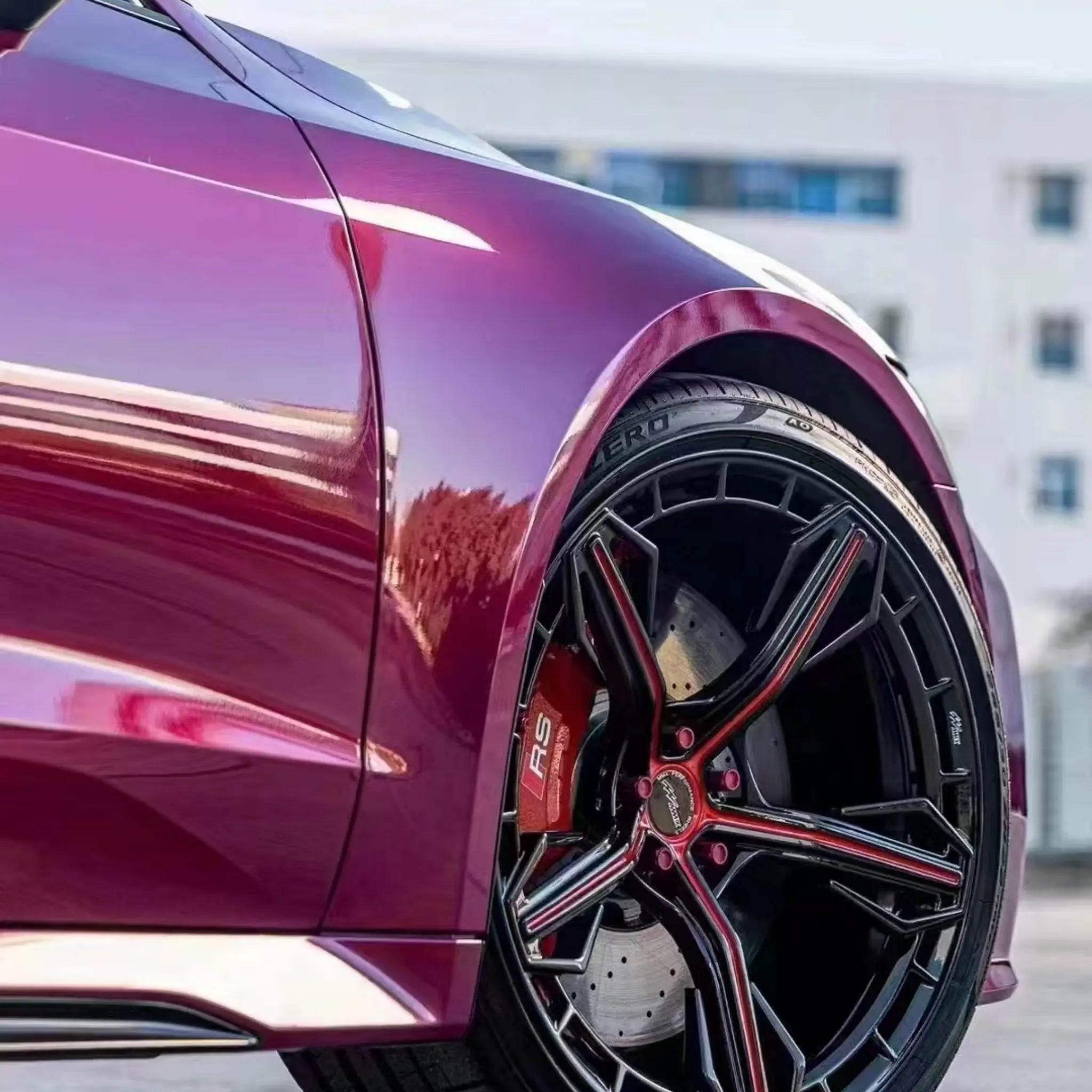 Glossy Metallic Rubellite Purple vinyl on Audi RS7 Sportback (C8) front-right corner - Kaleido