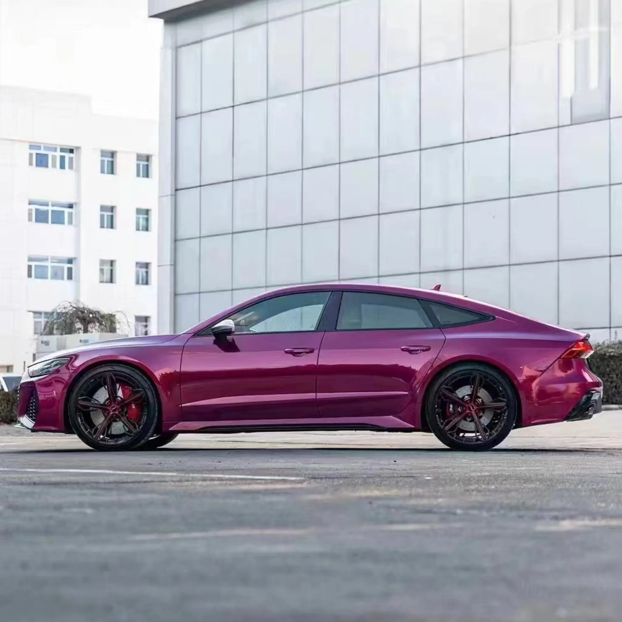 Left side profile of an Audi RS7 Sportback with Glossy Metallic Rubellite Purple vinyl - Kaleido