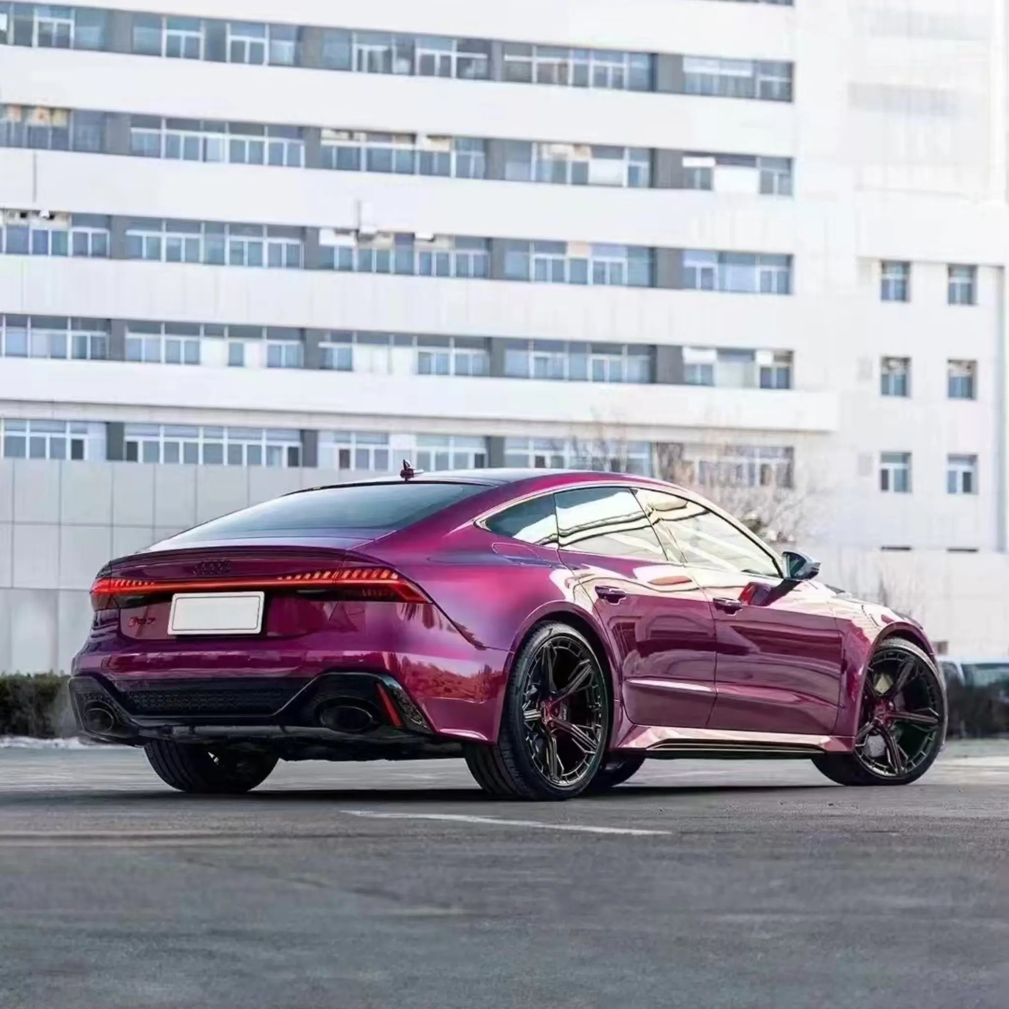 Wide rear-right view of Audi RS7 Sportback (C8) in Glossy Metallic Rubellite Purple wrap - Kaleido