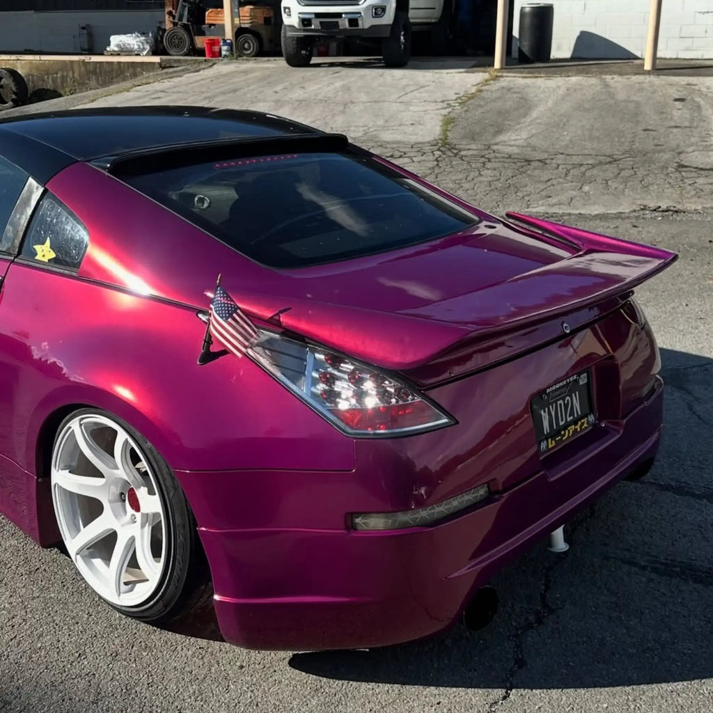 Glossy Metallic Rubellite Purple wrap on a modified Nissan Silvia S15 - rear-left view - Kaleido