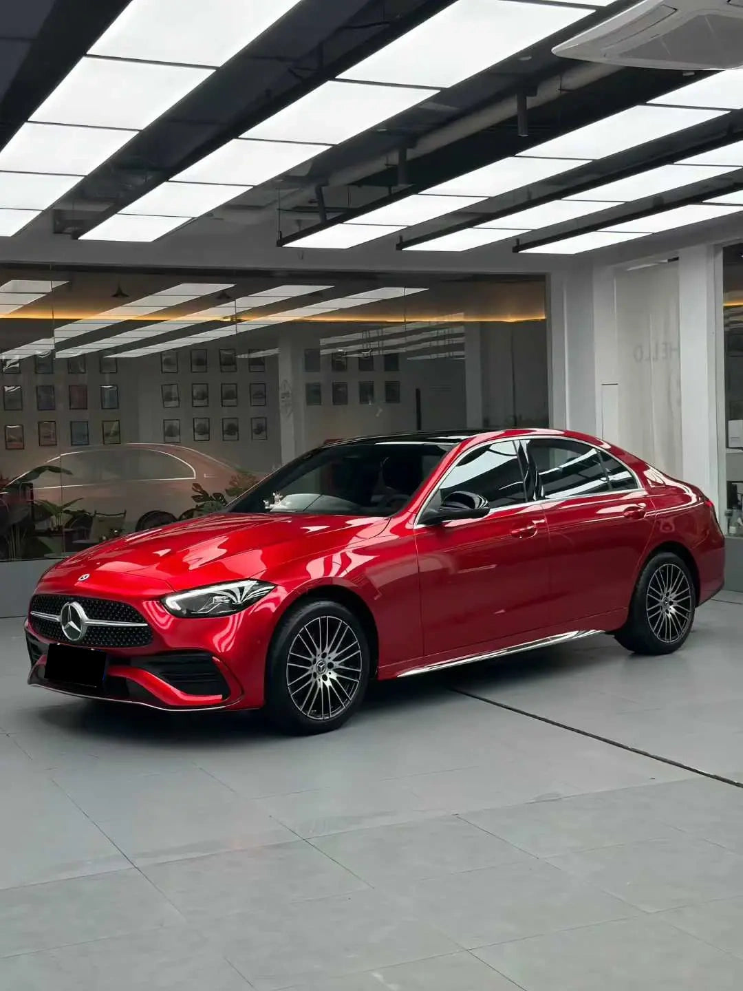 Full left side profile of a Mercedes-Benz C-Class (W206) sedan in Glossy Metallic Vampire Red - Kaleido