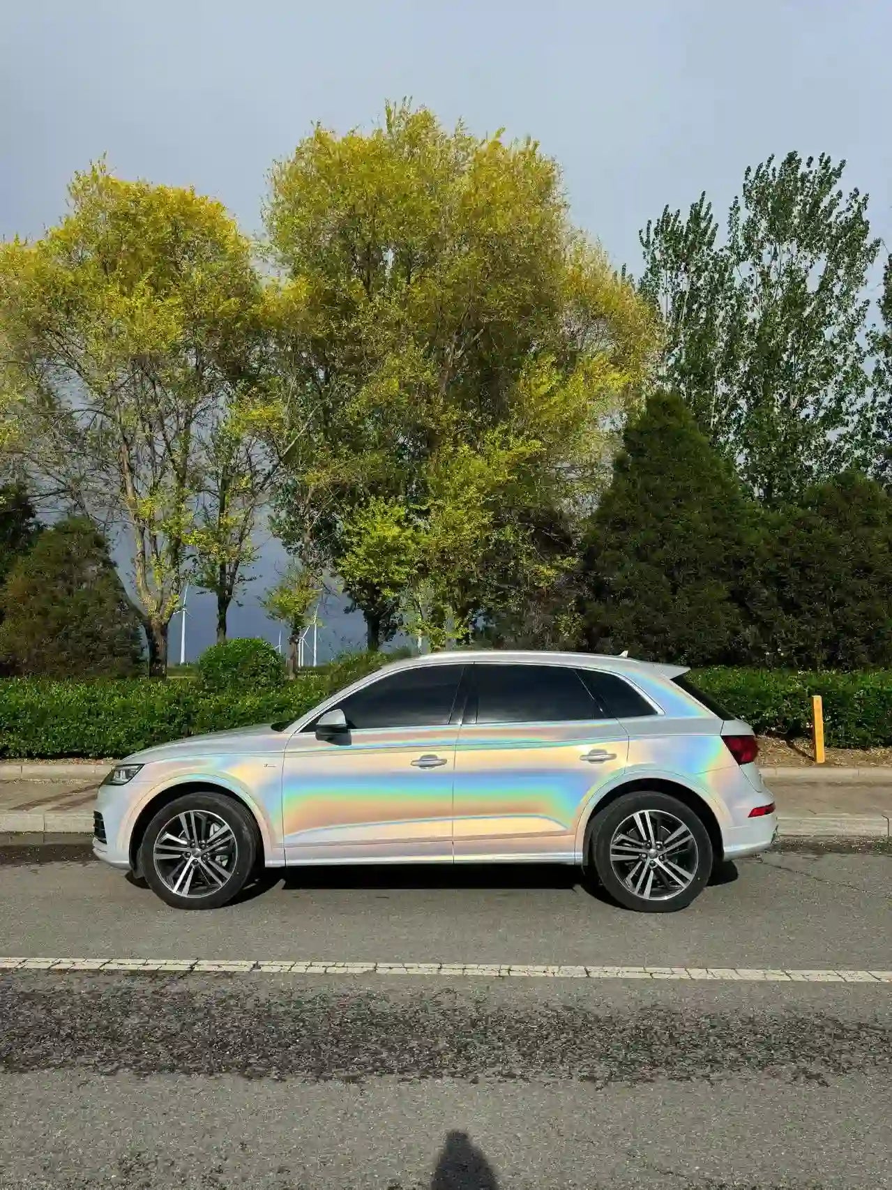 Audi Q2L with Laser Gloss Prismatic White wrap - left side view - Kaleido