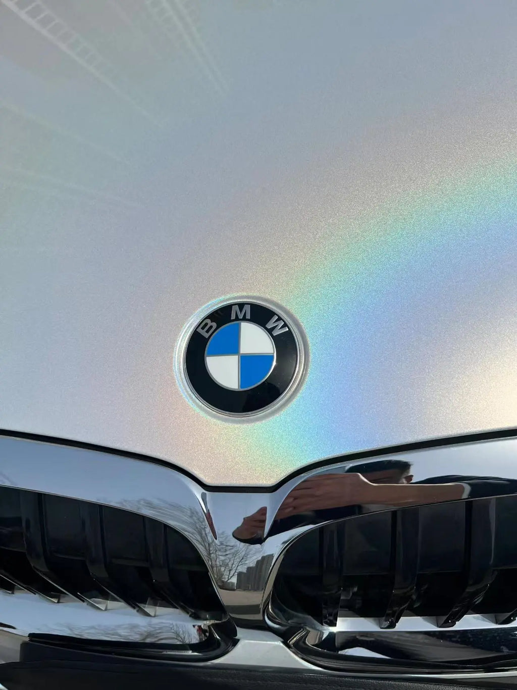Macro shot of Laser Gloss Prismatic White wrap around BMW 3 Series emblem - Kaleido