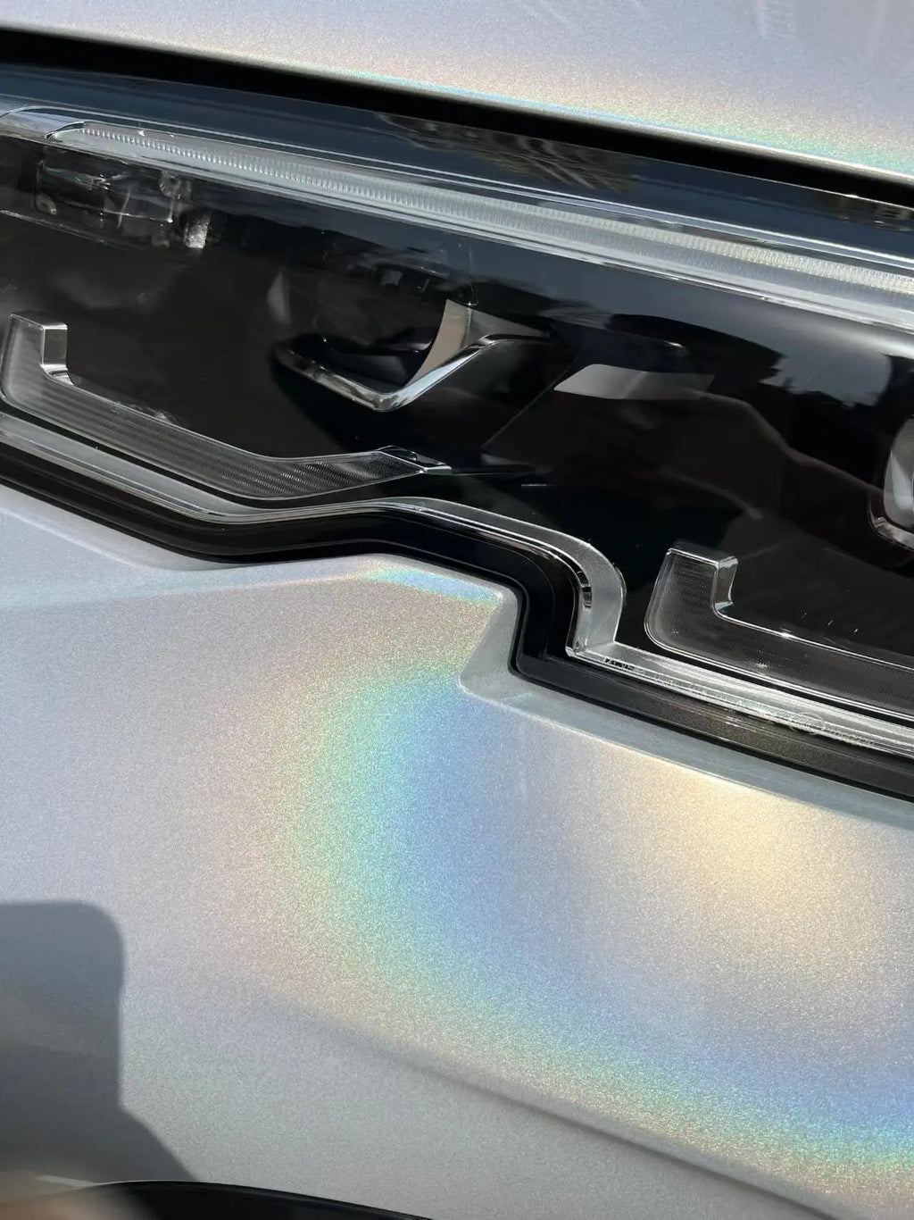 Close-up of Laser Gloss Prismatic White film on BMW 3 Series front bumper - Kaleido