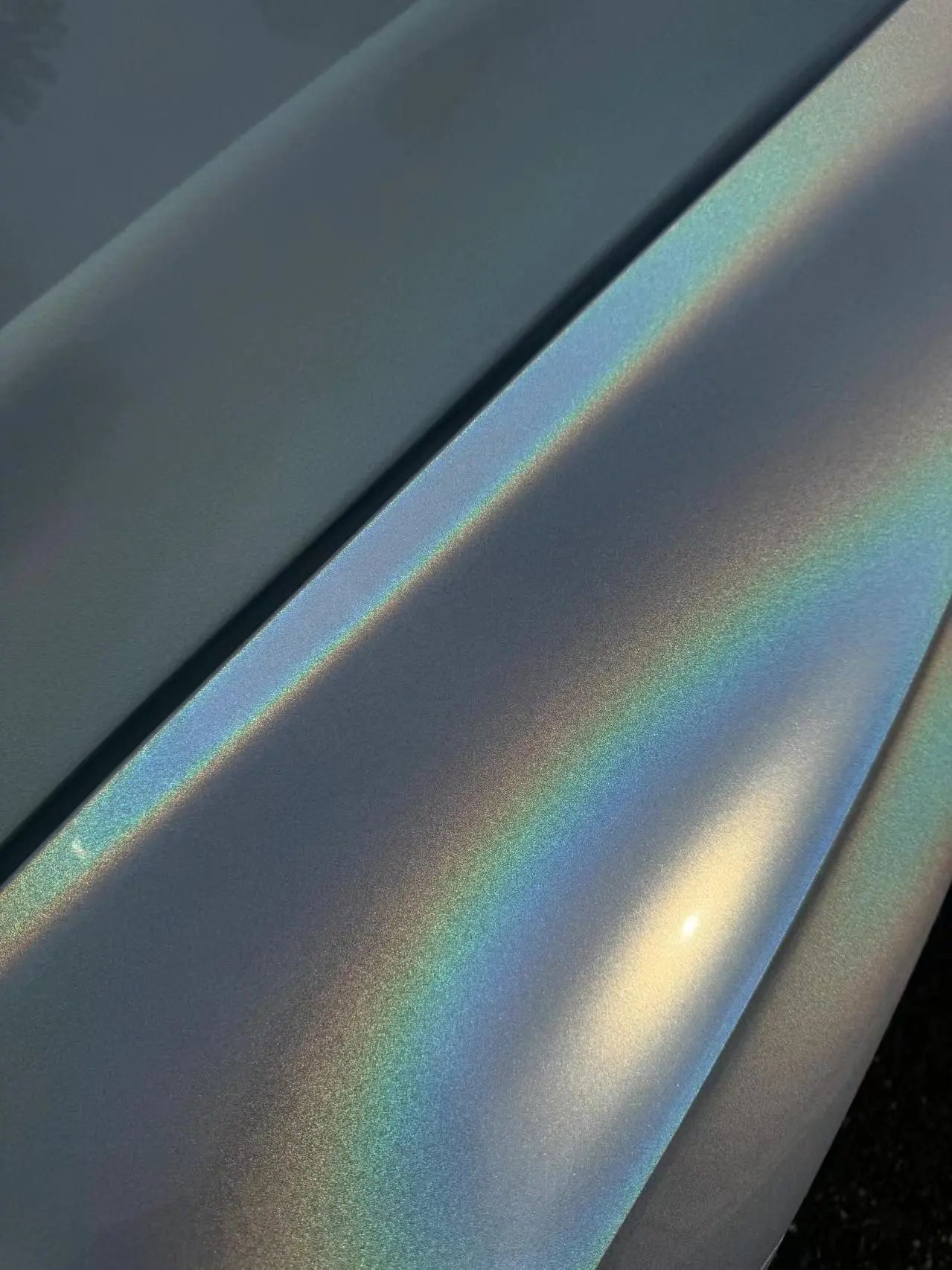 Close-up of Laser Gloss Prismatic White film on BMW 3 Series hood - holographic effect - Kaleido