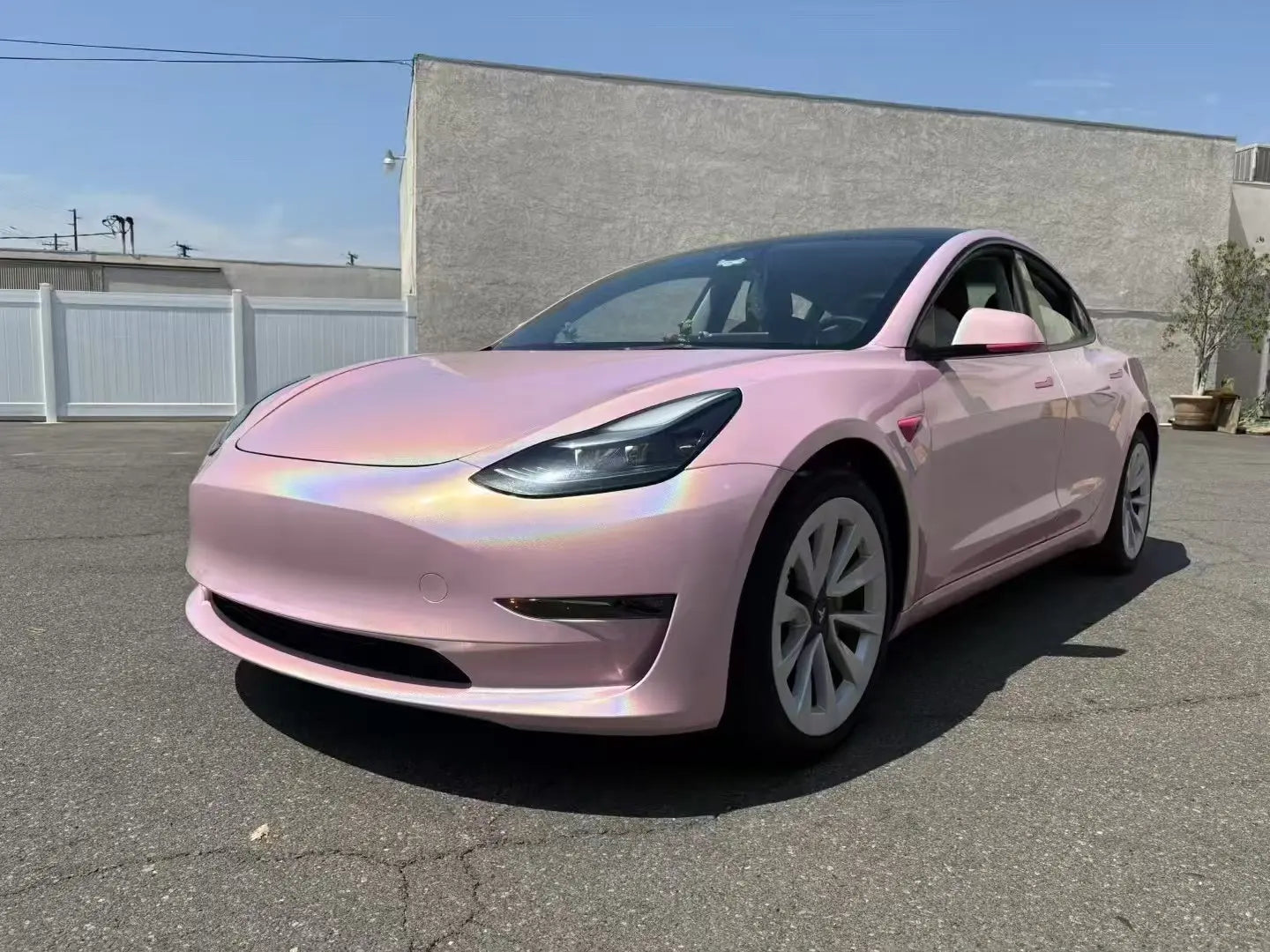 Laser Gloss Rouge Pink wrap on Tesla Model 3 front-left - holographic color shift - Kaleido