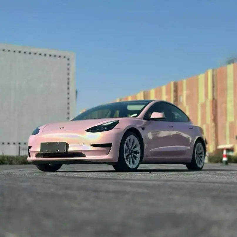 Wide front-left view of Laser Gloss Rouge Pink wrapped Tesla Model 3 - Kaleido