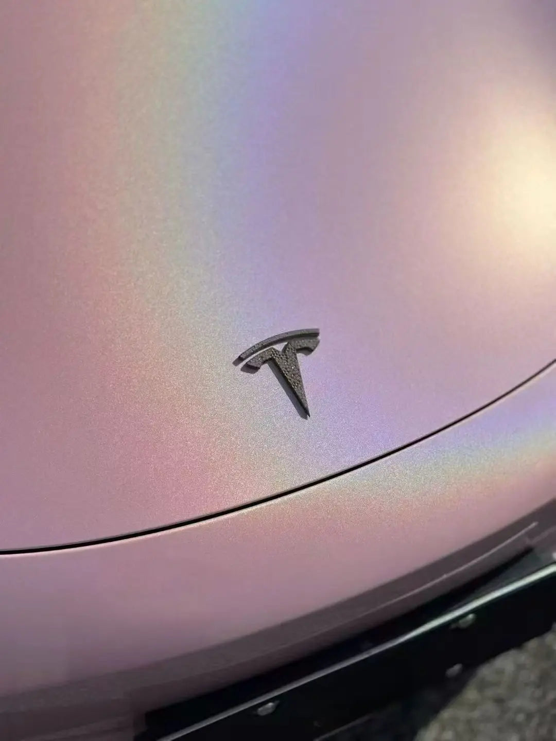 Close-up of Laser Gloss Rouge Pink vinyl on Tesla Model 3 hood - rainbow holographic detail - Kaleido