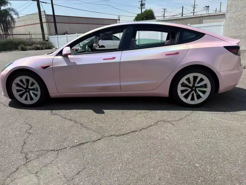 Tesla Model 3 in Laser Gloss Rouge Pink vinyl - left side outdoor view showing full holographic effect - Kaleido