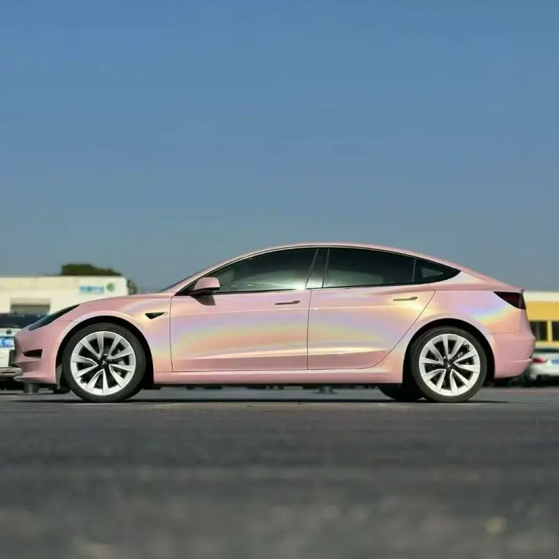 Tesla Model 3 with Laser Gloss Rouge Pink film - outdoor left side showing rainbow spectrum - Kaleido