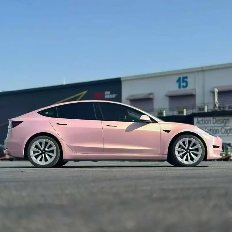 Panoramic right side view of Tesla Model 3 in Laser Gloss Rouge Pink vinyl - Kaleido