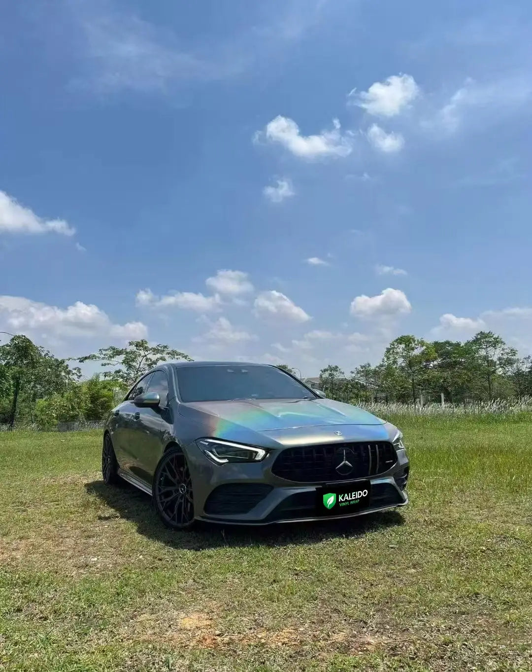 Mercedes-Benz CLA-Class in Laser Holographic Gray vinyl wrap - front view showcasing holographic rainbow effect - Kaleido