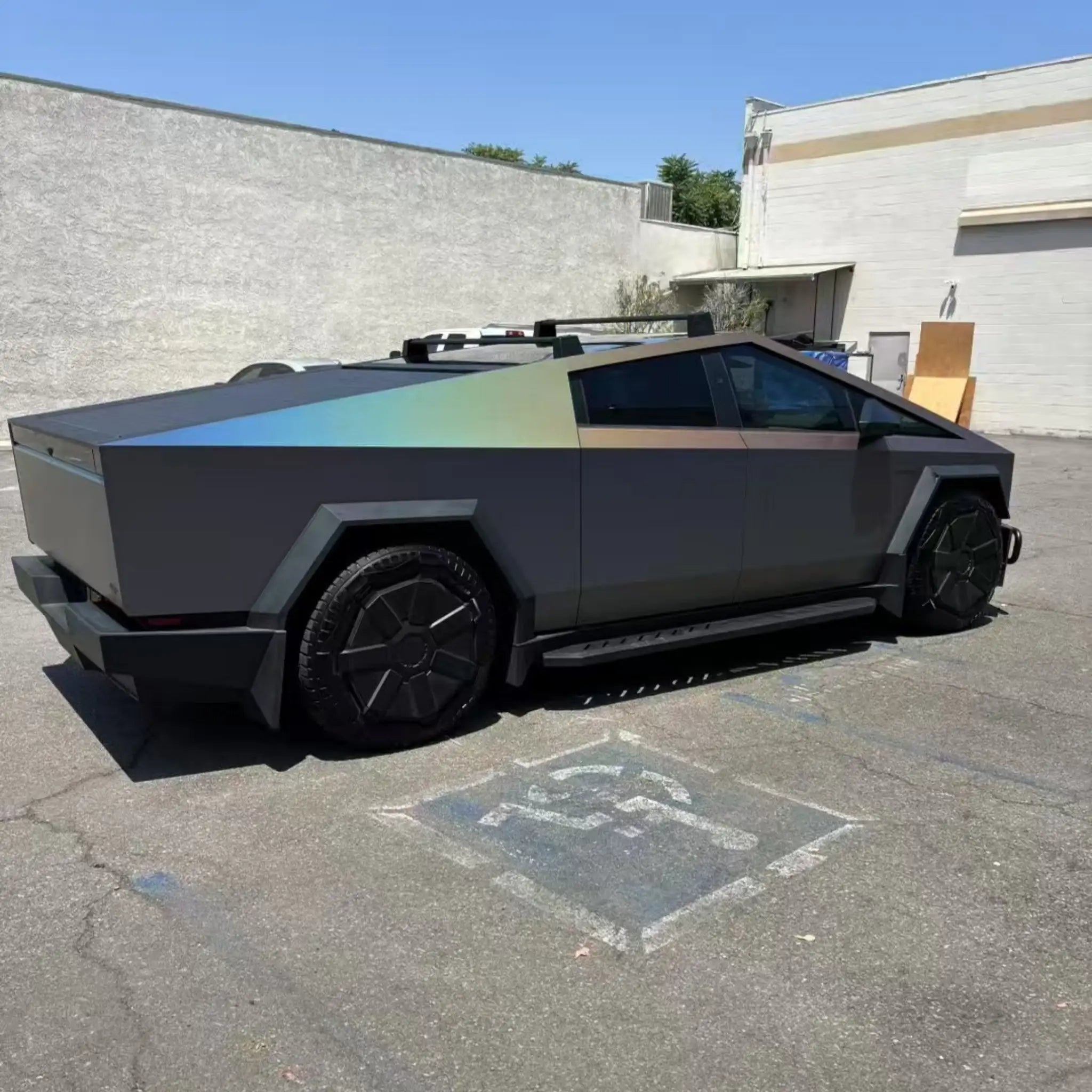 Laser Satin Gray vinyl wrap on Tesla Cybertruck - rear-right view showing matte base and rainbow holographic effect - Kaleido