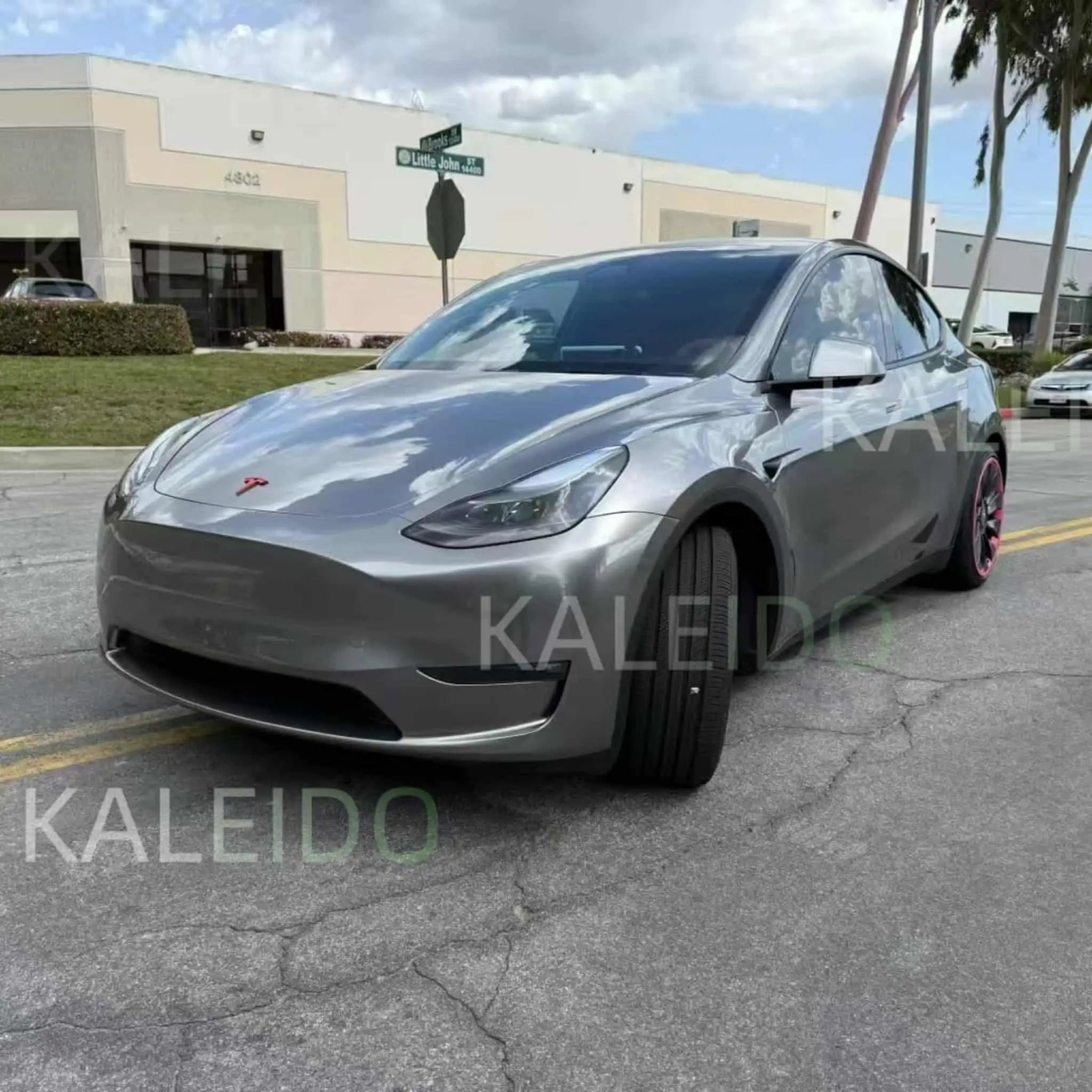 Tesla Model 3 in Liquid Silver vinyl wrap - front-left angle showing mirror-like finish - Kaleido