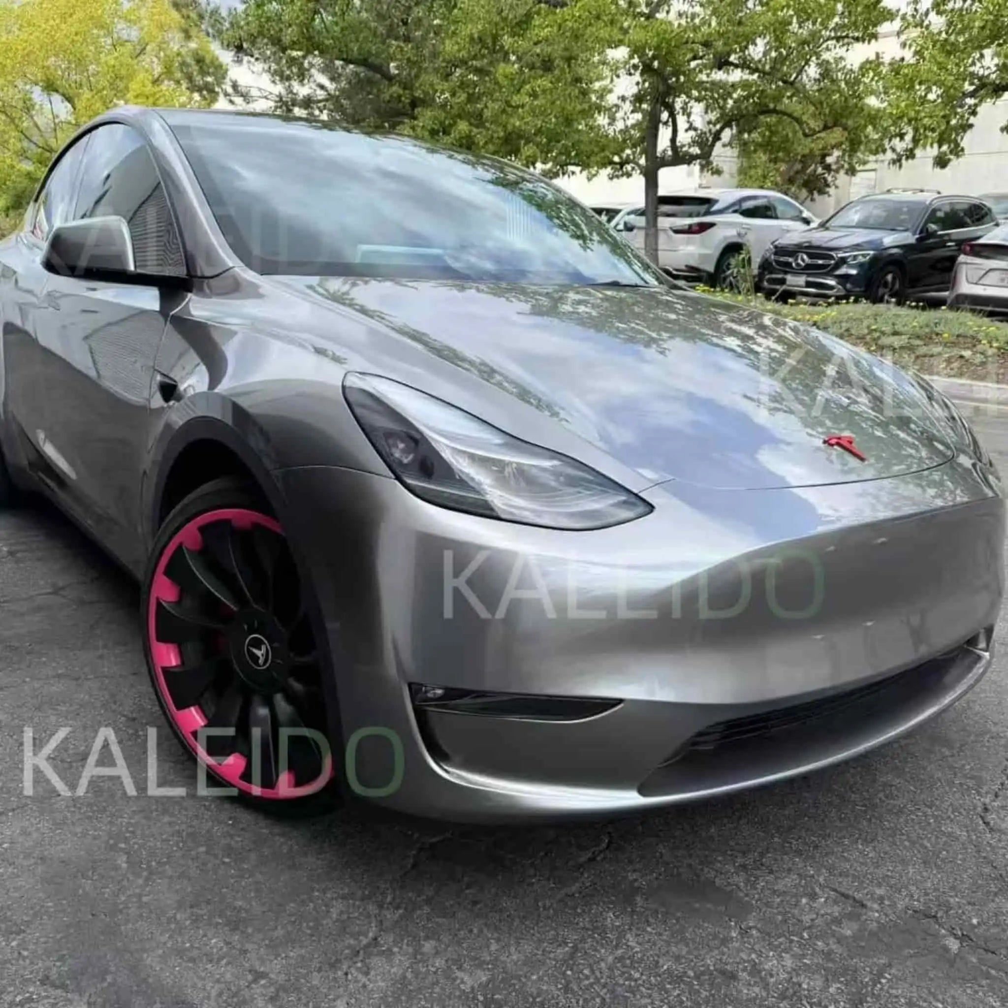 Close-up front-right view of Tesla Model 3 in Liquid Silver gloss metallic film - Kaleido