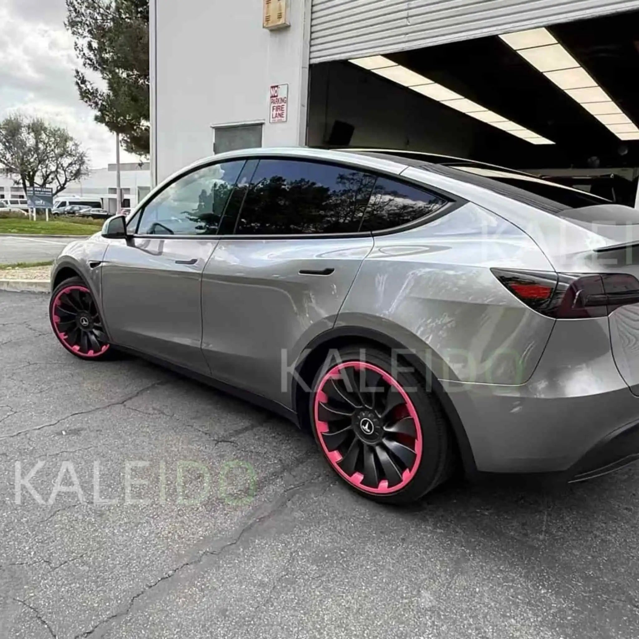 Liquid Silver vinyl wrap on Tesla Model 3 - rear-left angle showcasing sleek sedan profile - Kaleido