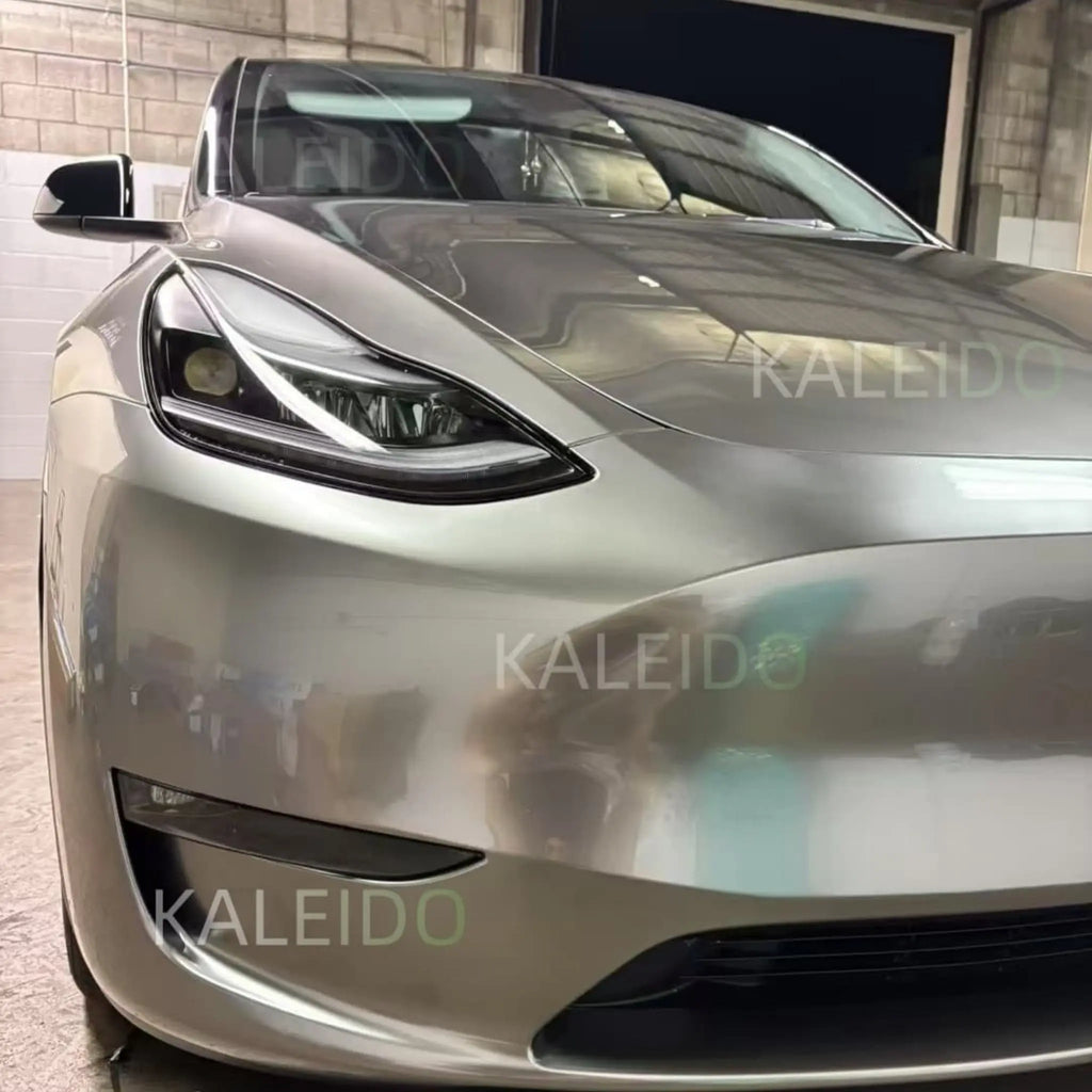 Close-up of Liquid Silver vinyl on Tesla Model Y front-right corner - metallic flake detail - Kaleido