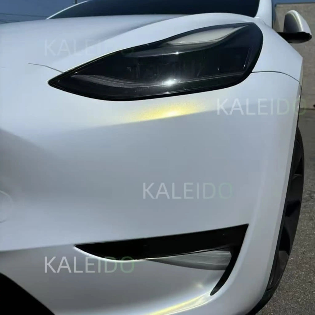 Close-up of Matte Diamond Iridescent White Gold vinyl on Tesla Model 3 front-left corner - matte texture detail - Kaleido