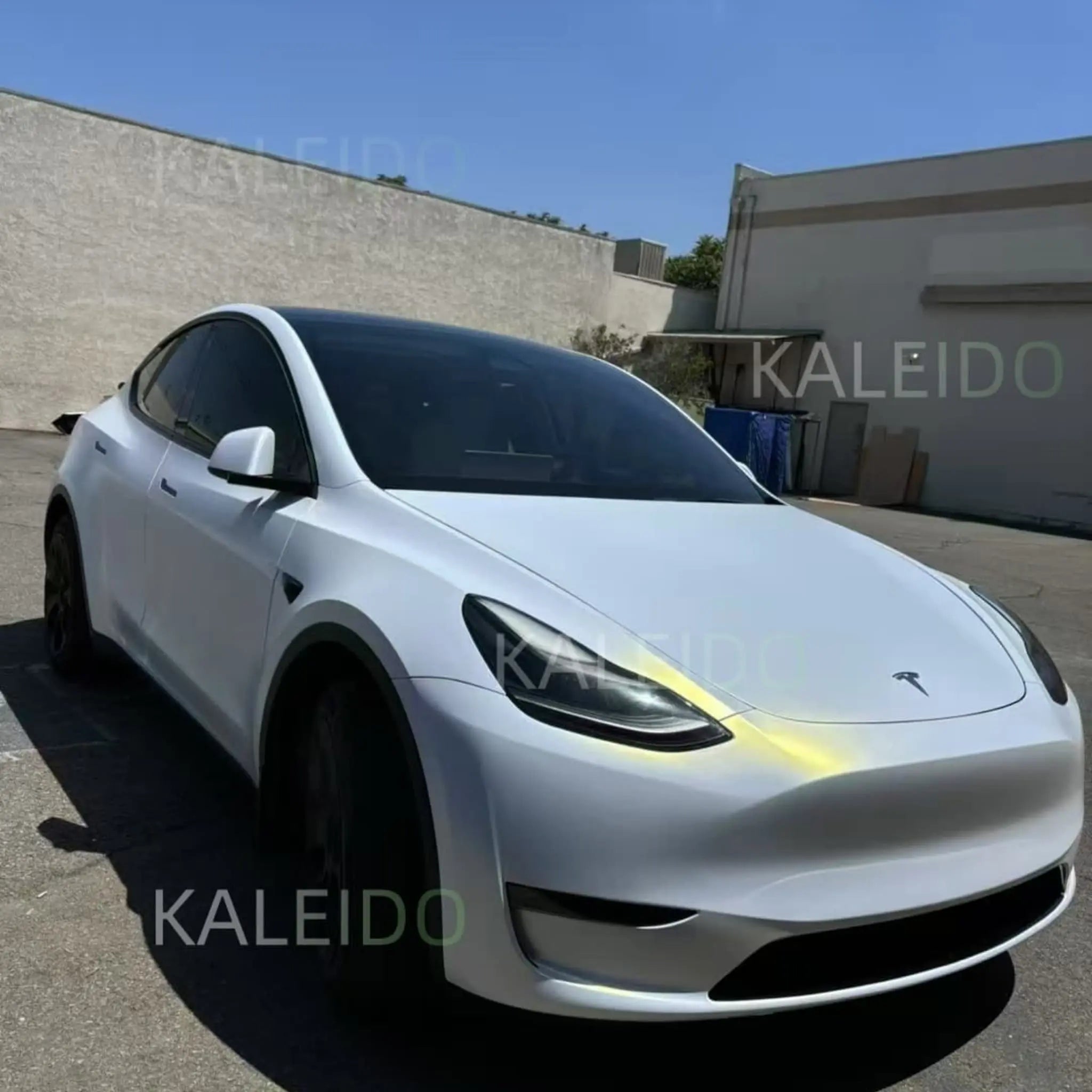 Tesla Model 3 in Matte Diamond Iridescent White Gold wrap - front-right angle with pearl shimmer - Kaleido