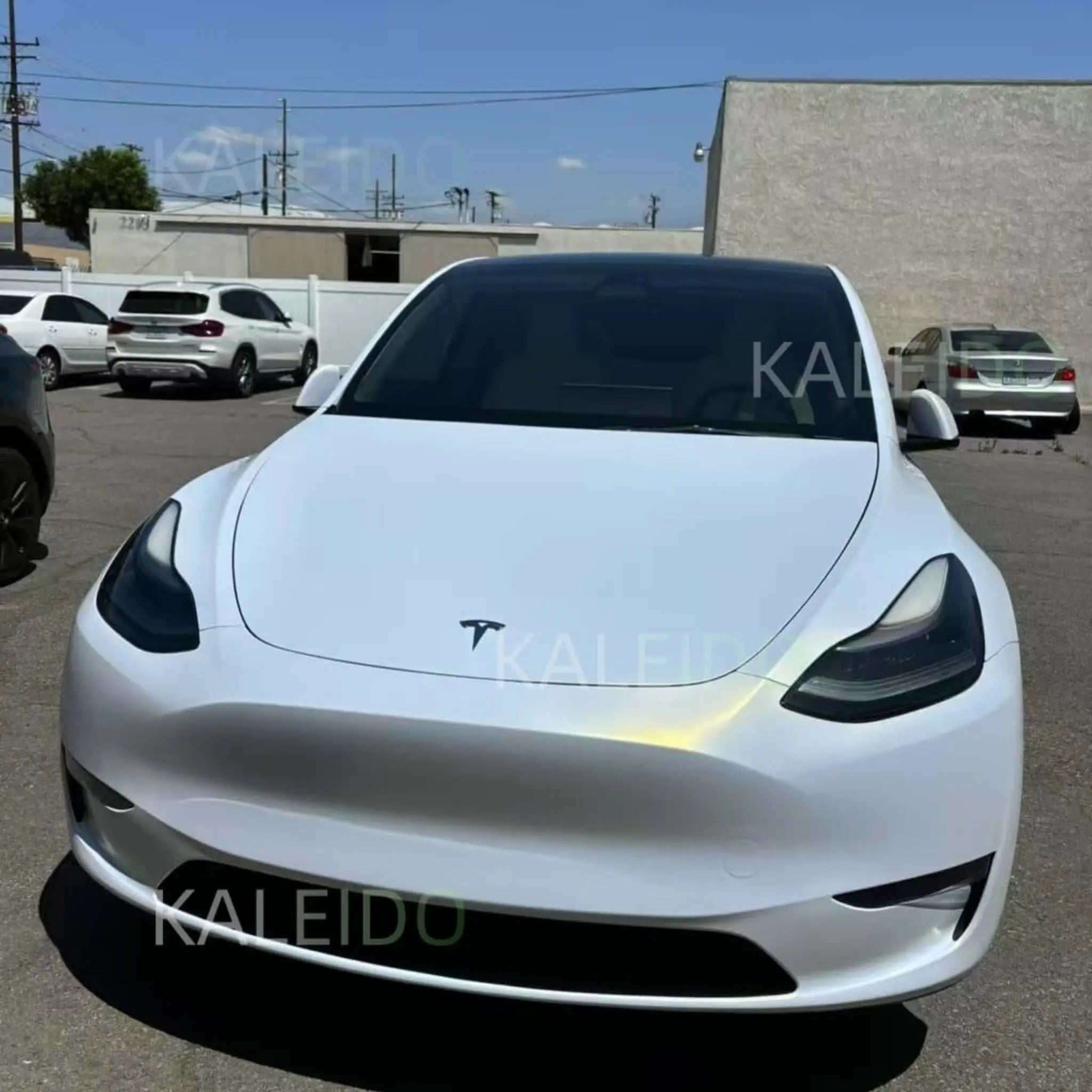 Matte Diamond Iridescent White Gold vinyl wrap on Tesla Model 3 - front view showing matte white-gold finish - Kaleido