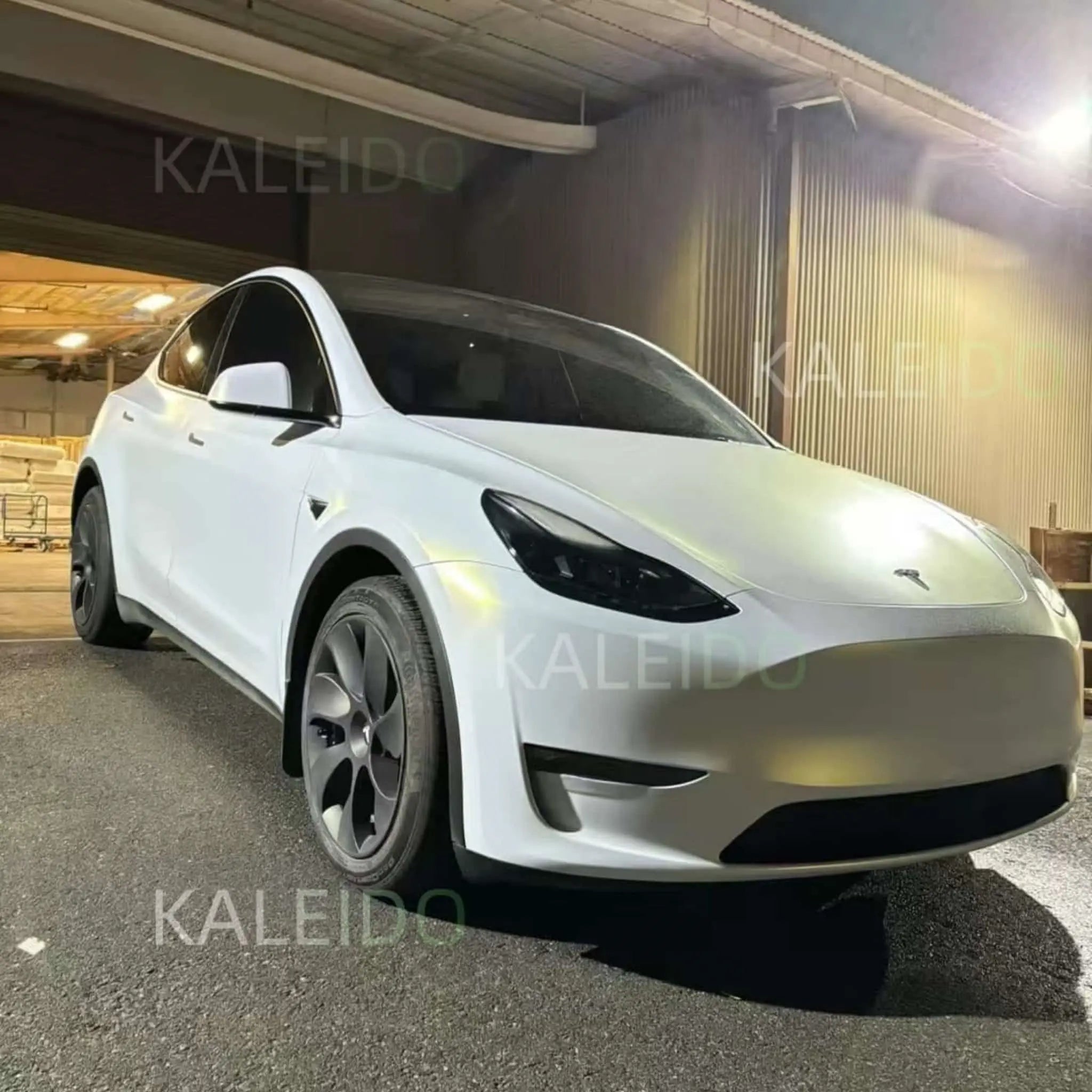 Tesla Model Y in Matte Diamond Iridescent White Gold wrap - front-right view showing SUV profile - Kaleido
