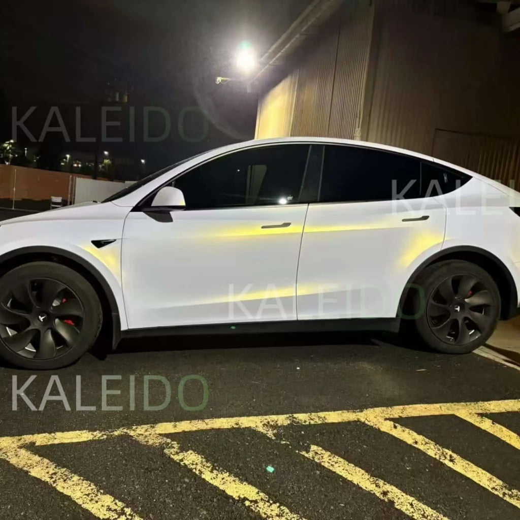 Left side profile of Tesla Model Y in Matte Diamond Iridescent White Gold matte vinyl wrap - Kaleido