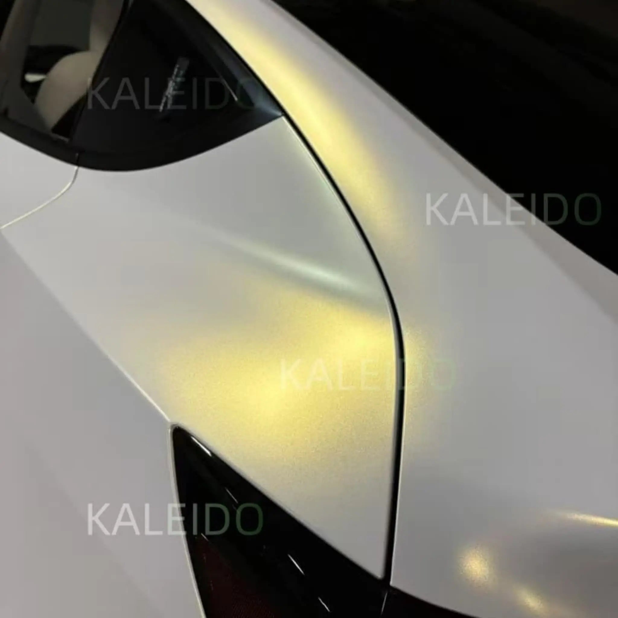 Detailed shot of Matte Diamond Iridescent White Gold film on Tesla Model Y rear fender - Kaleido