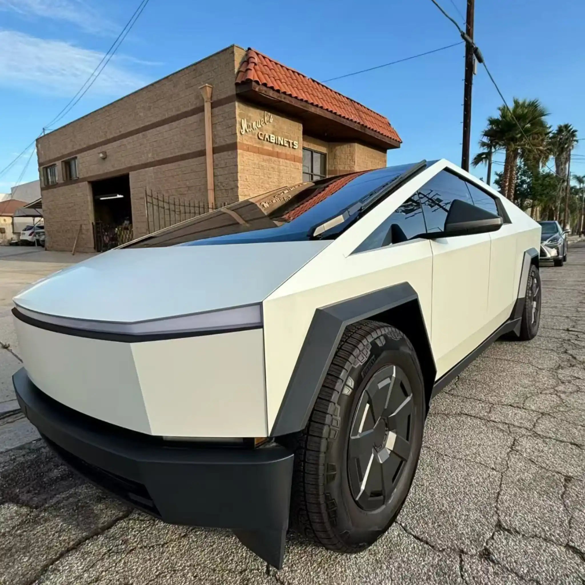 Matte Lunar White wrap on Tesla Cybertruck - front-left angle with futuristic design - Kaleido