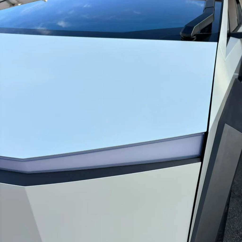 Detailed close-up of Matte Lunar White wrap on Tesla Cybertruck front-left corner - Kaleido