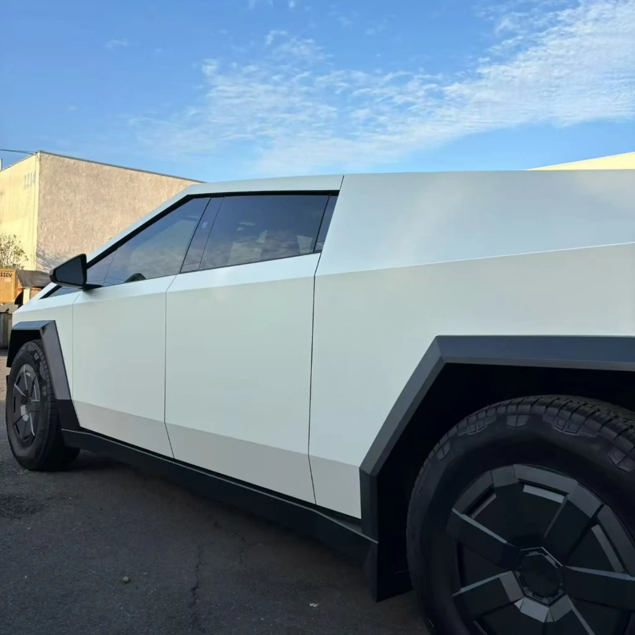 Matte Lunar White film on Tesla Cybertruck - rear-left angle showing sharp lines - Kaleido