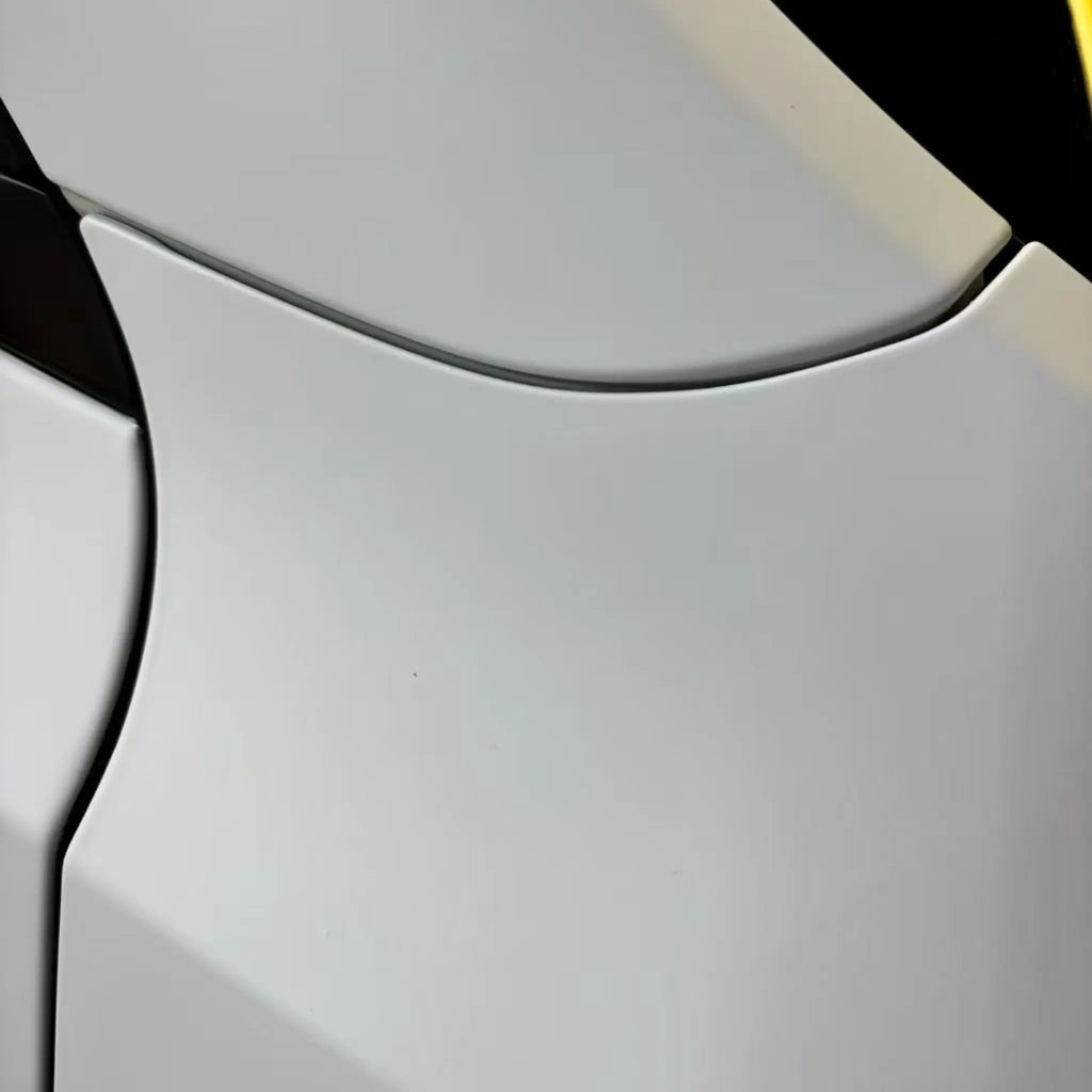 Detailed shot of Matte Lunar White vinyl on Tesla Model Y fender - smooth matte texture - Kaleido