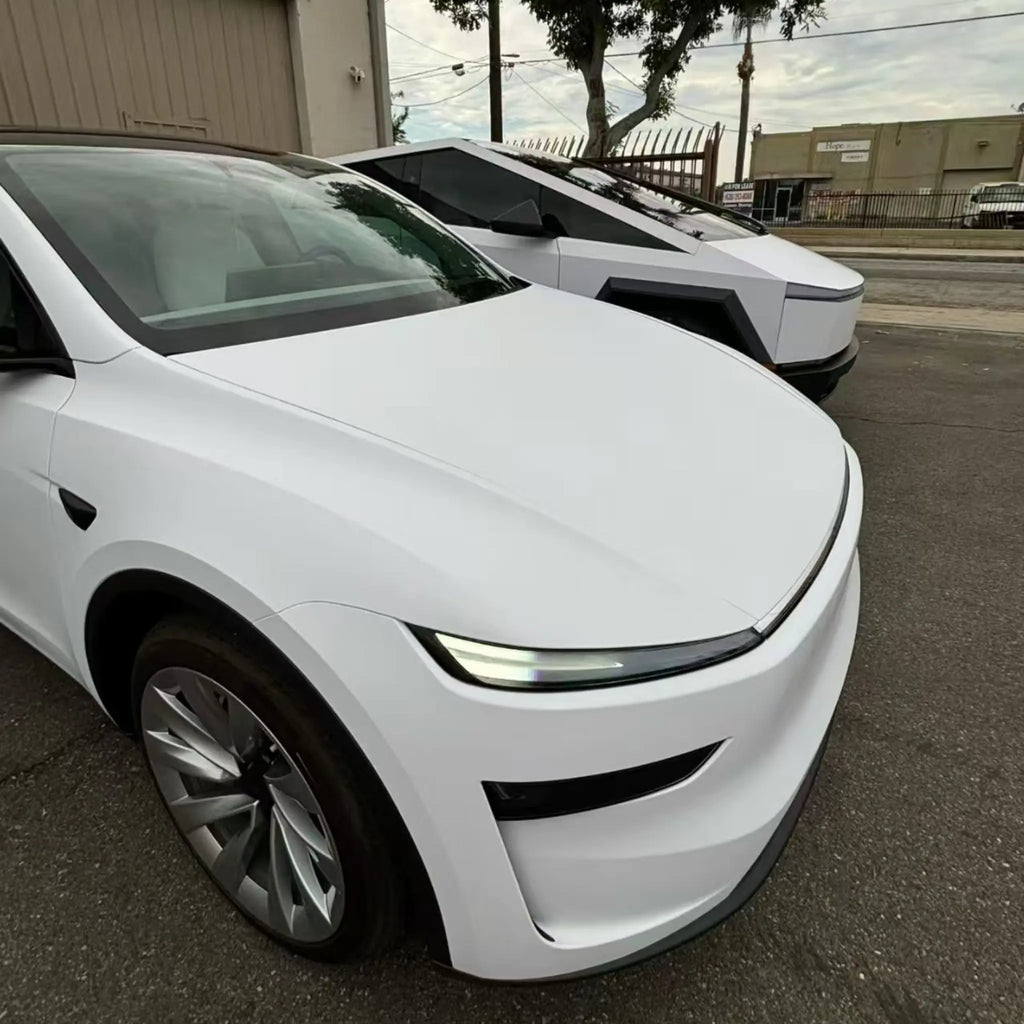 Close-up of Matte Lunar White film on Tesla Model Y front-right bumper area - Kaleido