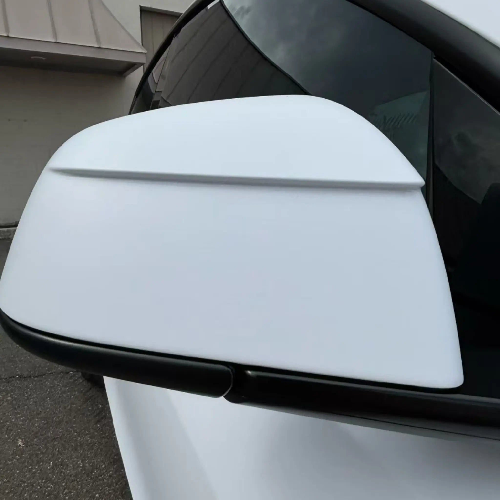 Macro detail of Matte Lunar White film on Tesla Model Y side mirror - Kaleido