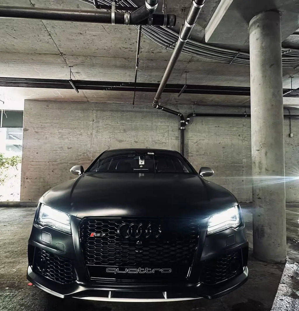 Front view of Silky Noir wrapped Audi RS7 indoors - showcasing smooth matte finish under studio lighting - Kaleido